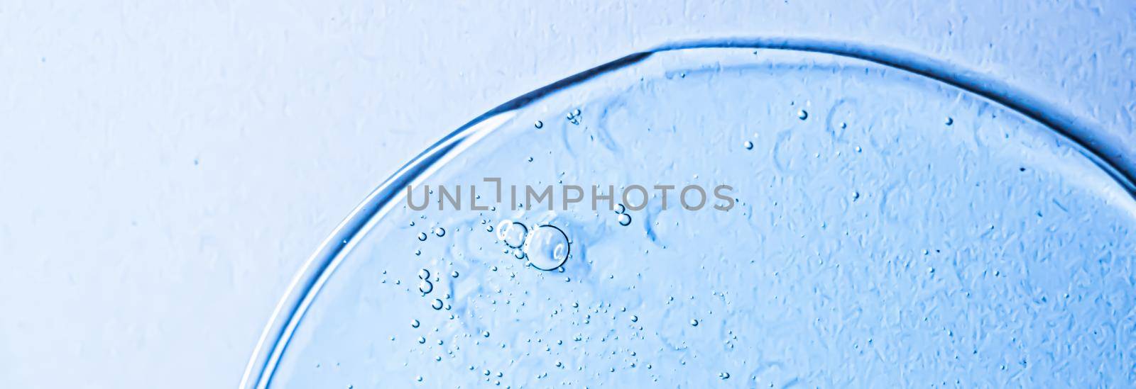 Blue gel texture on glass as cosmetics background, hygiene and science closeup