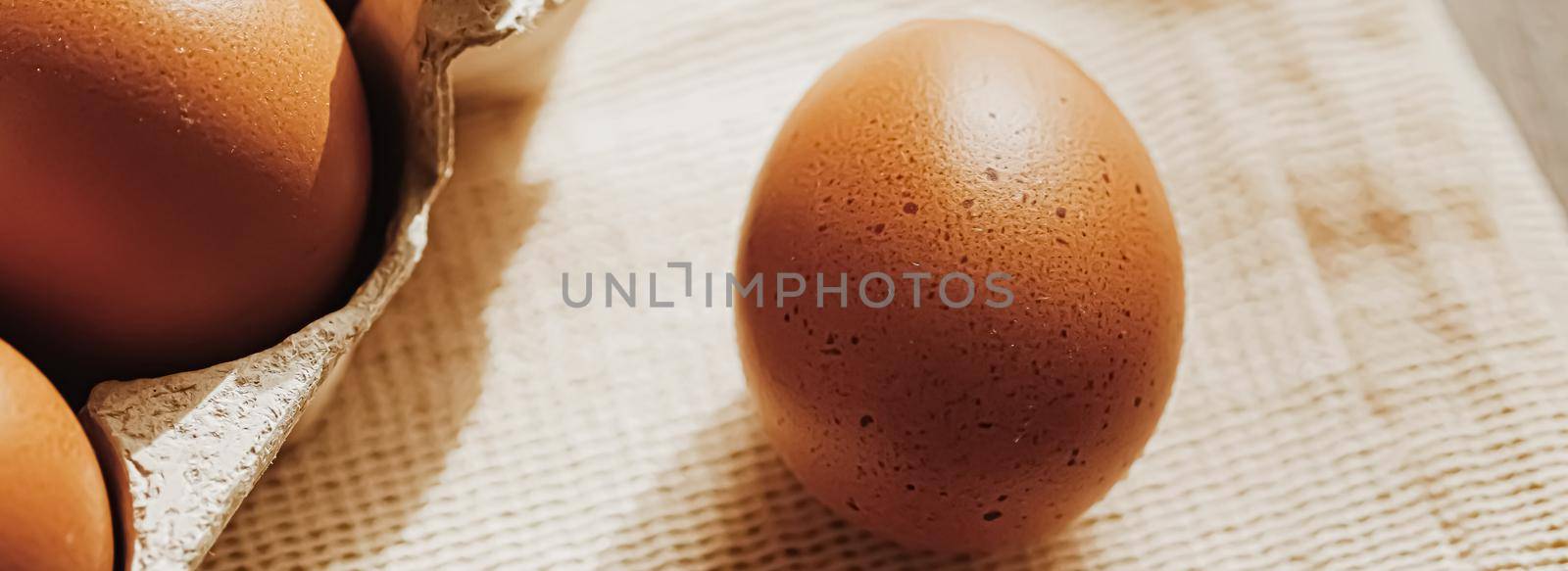 organic farm eggs in egg box and rustic cloth napkins, closeup