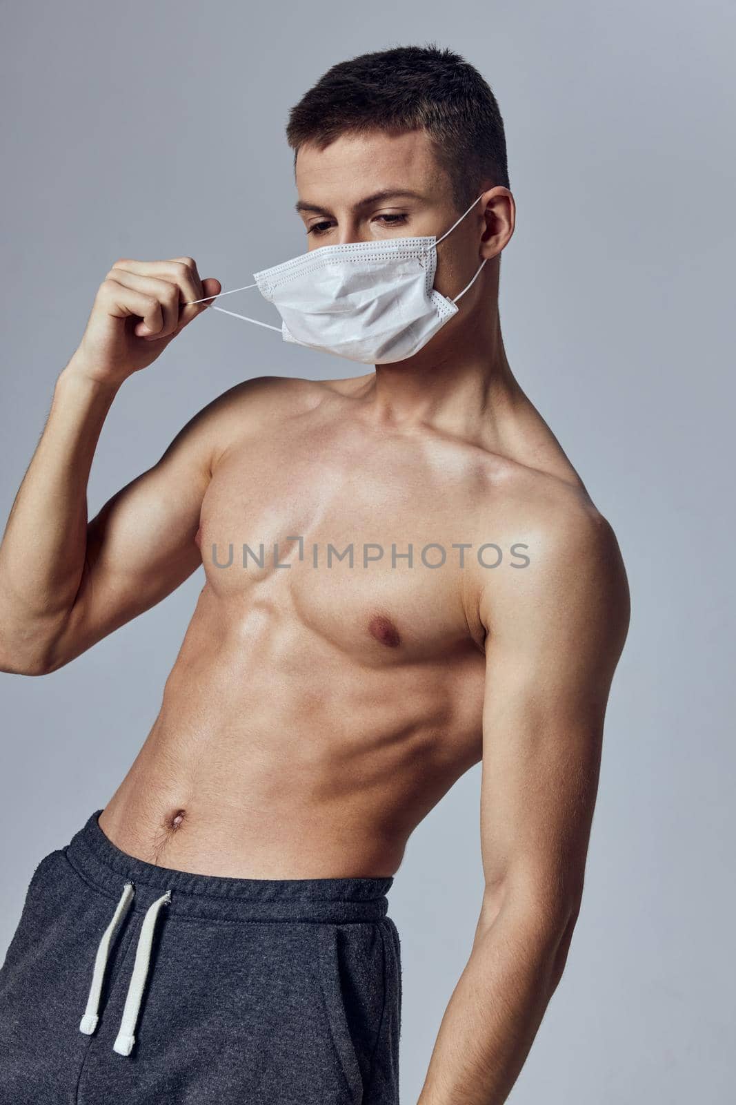 sporty man with inflated torso medical mask protection posing workout. High quality photo