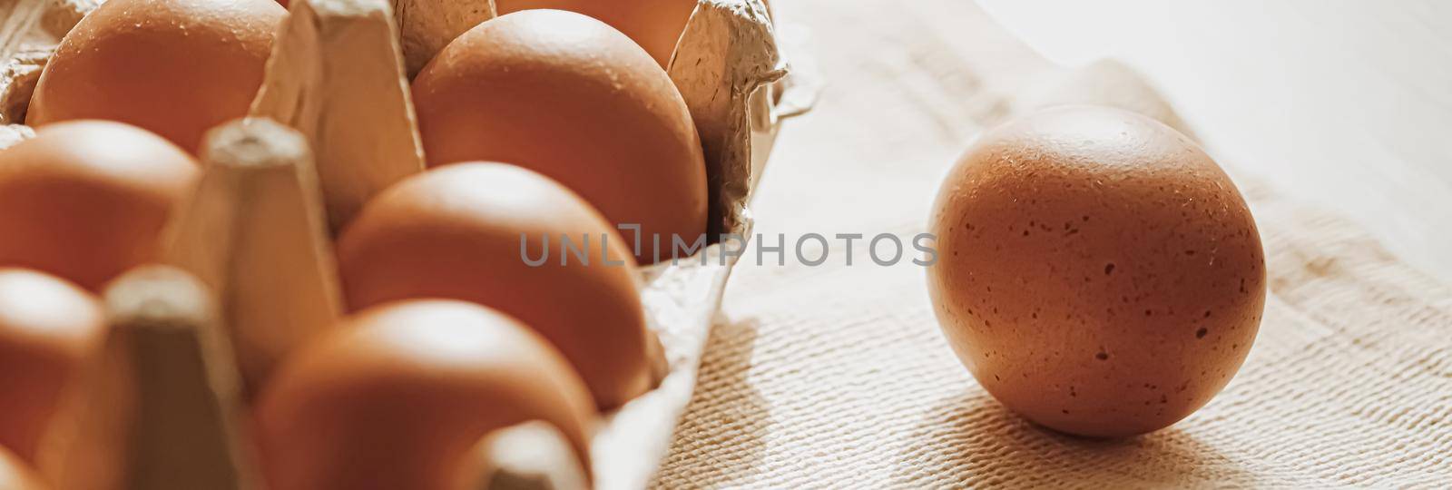 organic farm eggs in egg box and rustic cloth napkins, closeup