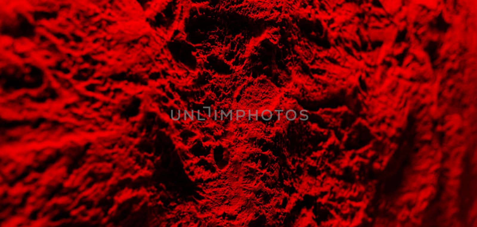 Texture of decorative plaster on concrete wall in dramatic red tonality. Abstract plaster background for design