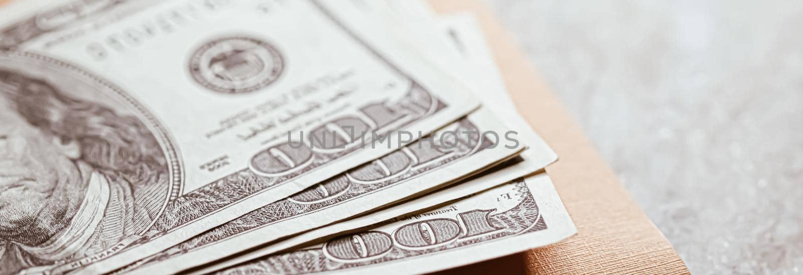 Money on home office desk, american dollars closeup