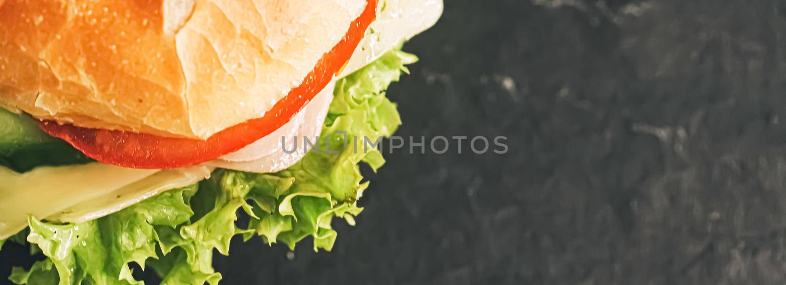 Sandwich with ham, cheese, veggies and lettuce, fast food closeup