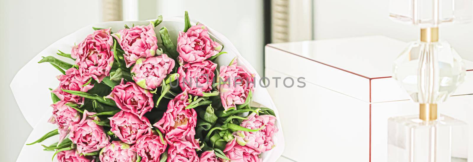 Bouquet of fresh cut pink tulips in an elegant interior, home decor closeup