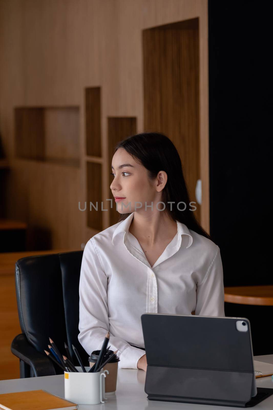 Business woman analysis with business data in tablet computer at her office