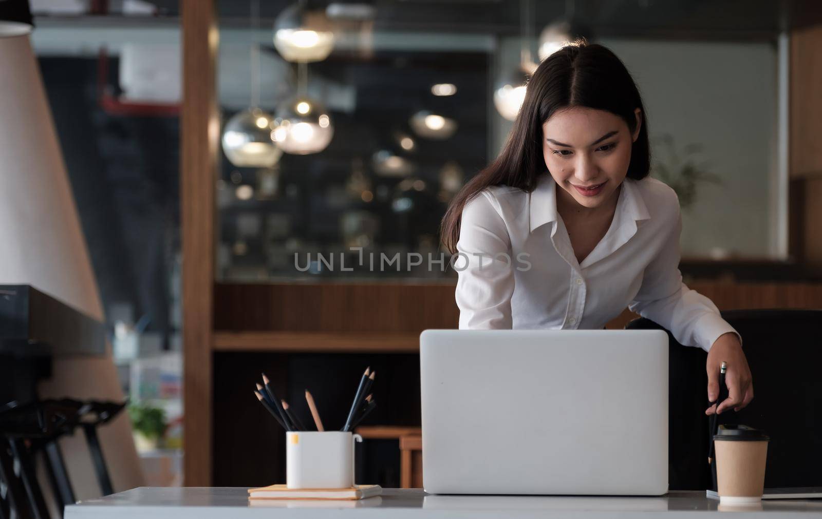 Young asian woman working laptop for business or online learning. by nateemee