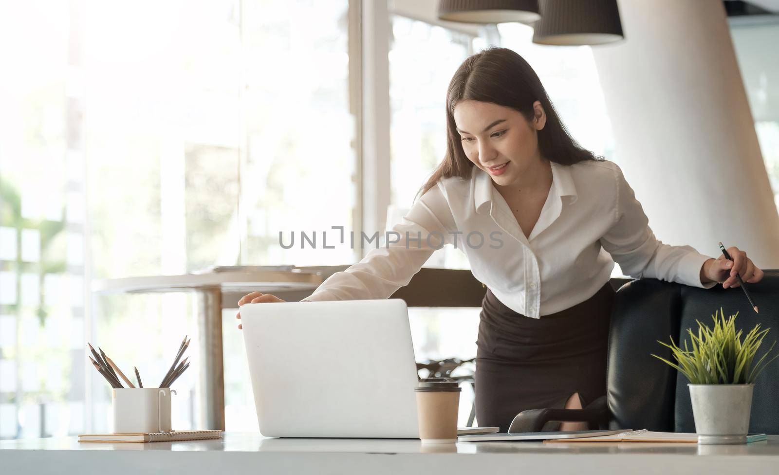 Young asian woman working laptop for business or online learning. by nateemee