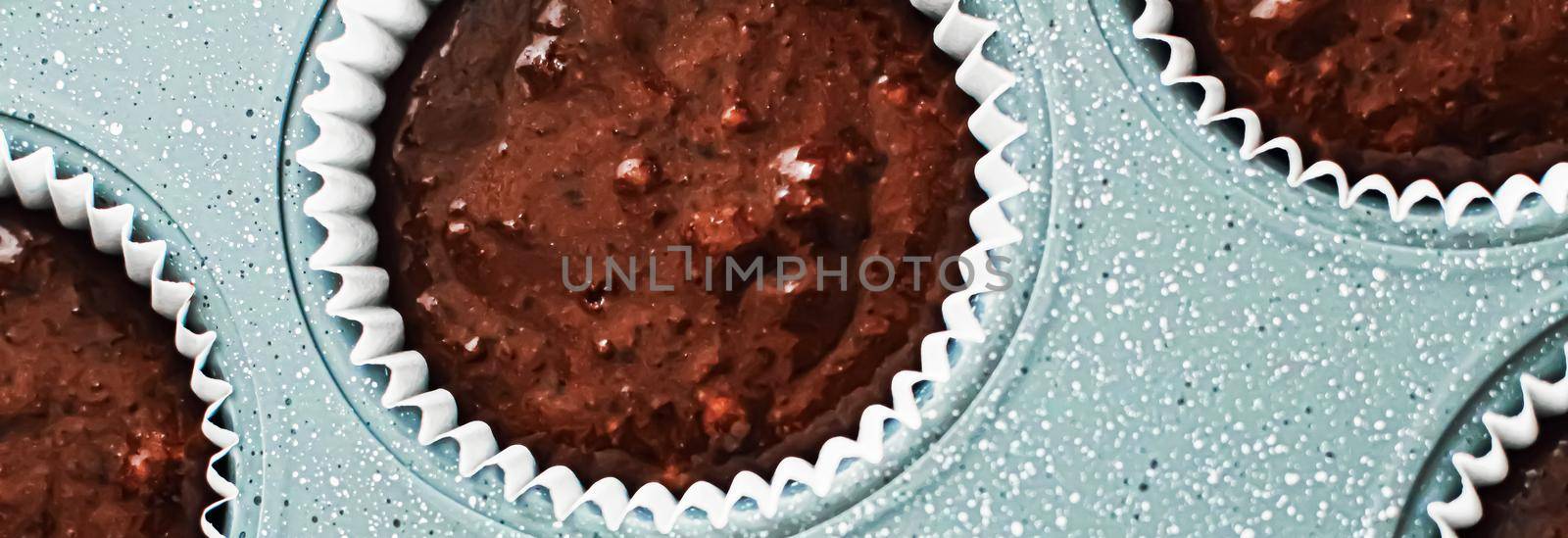 Chocolate muffin or cupcake batter in a pan ready to bake, homemade comfort food recipe by Anneleven