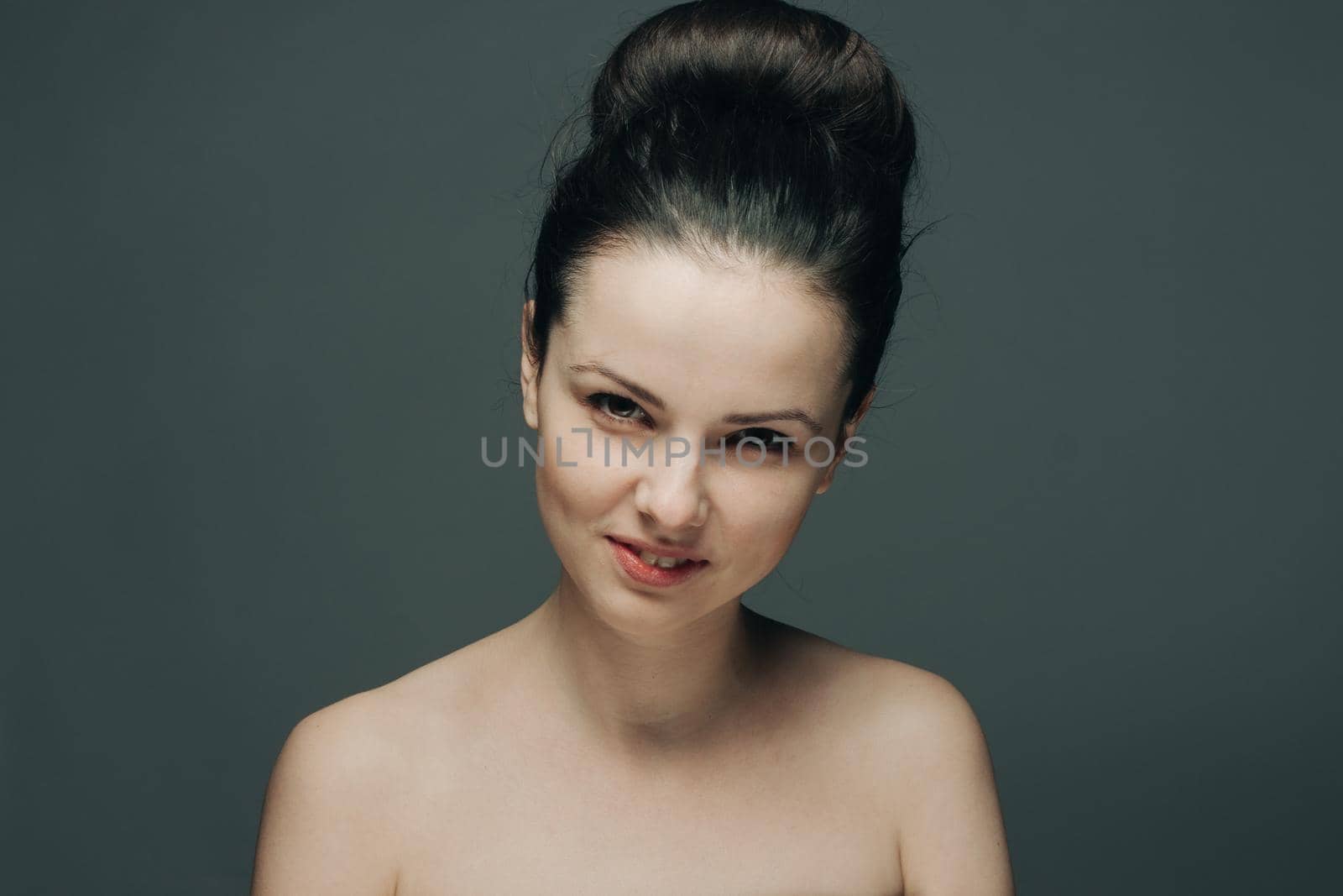 brunette with bare shoulders surprised look emotions clear skin. High quality photo