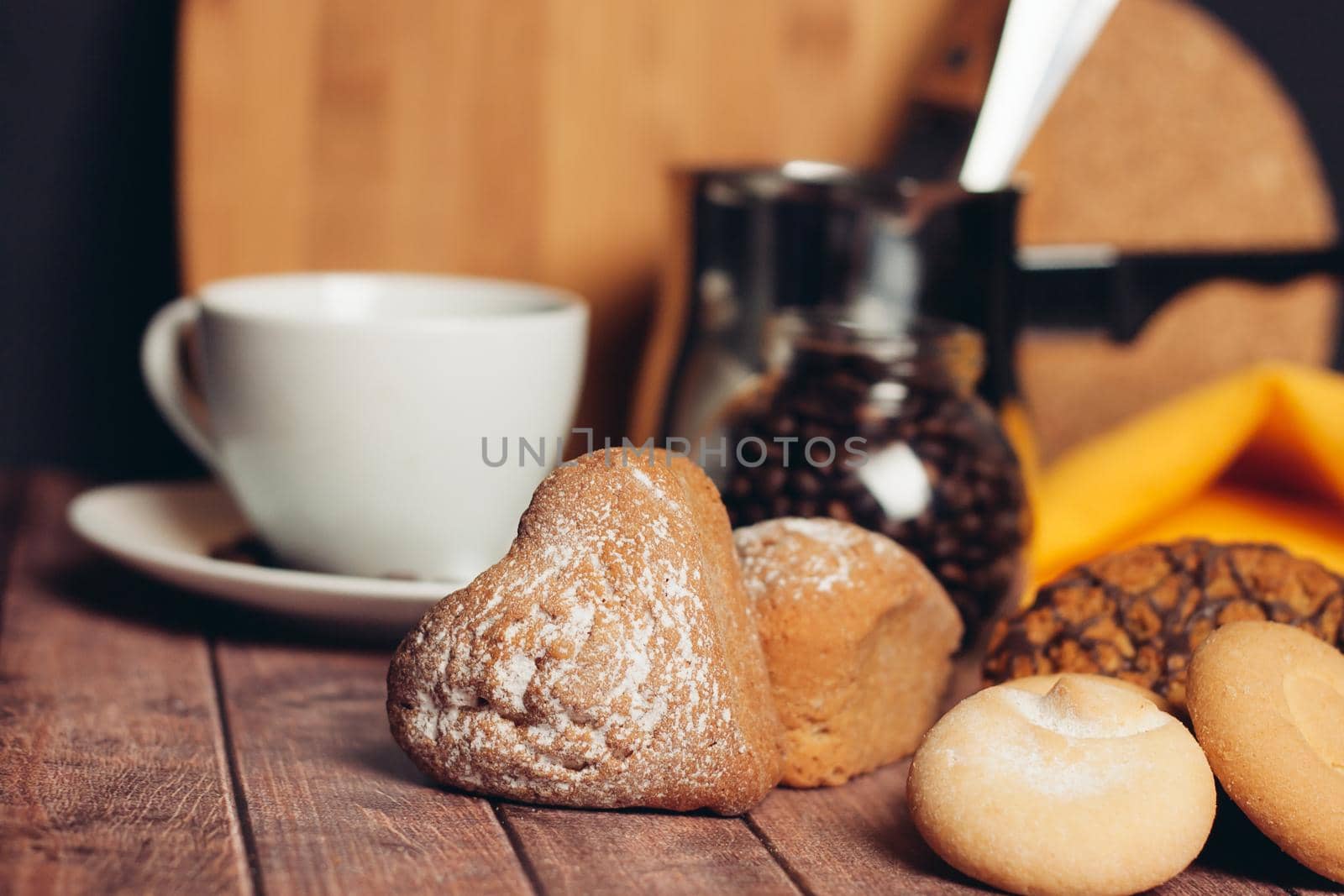 miscellaneous cookies sweets a cup of tea on a wooden table eating. High quality photo