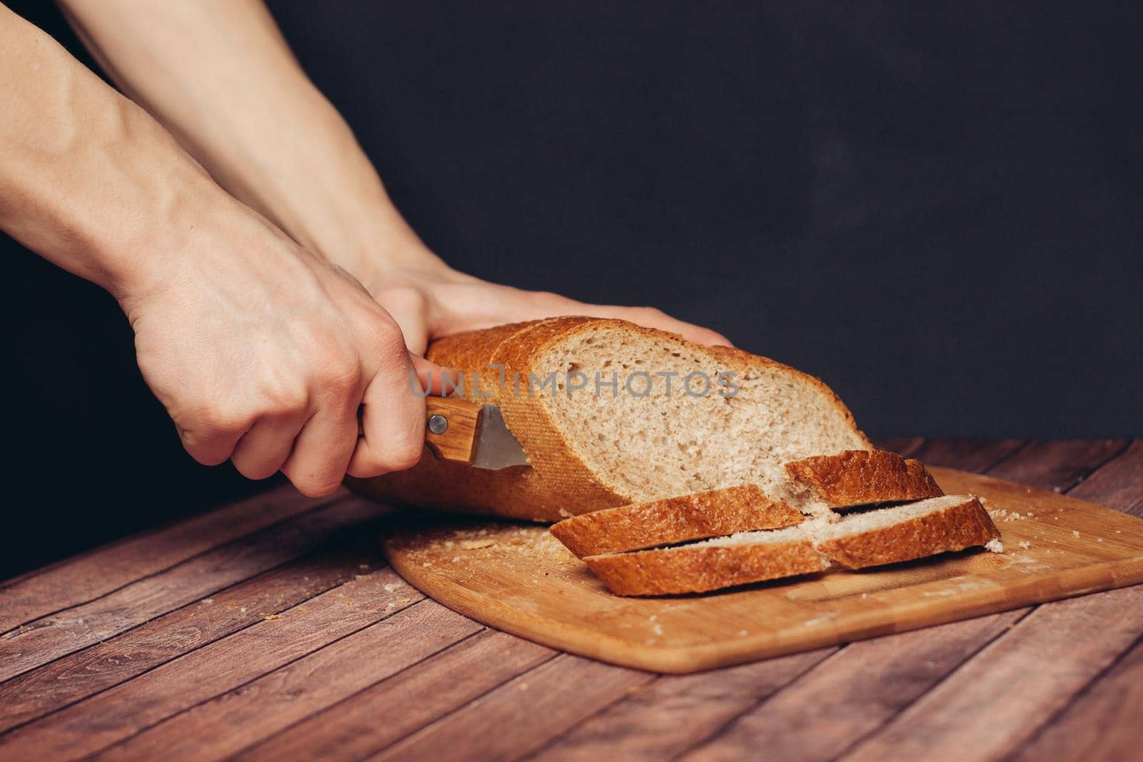 cutting a fresh loaf on a cutting board crispy bread. High quality photo