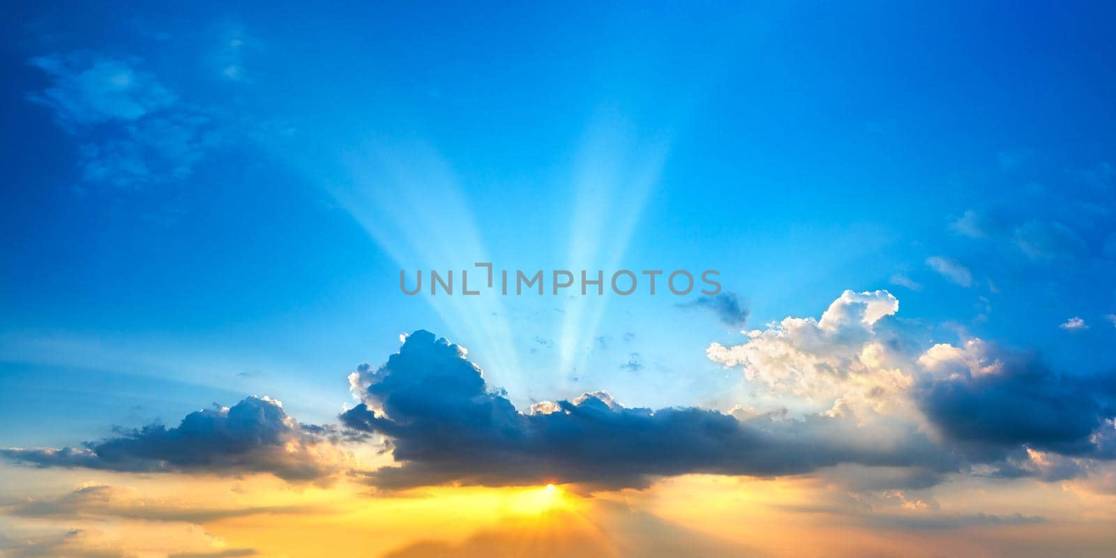 Sunset  with cloud and ray light on clouds in a blue and orange sky in twilight time