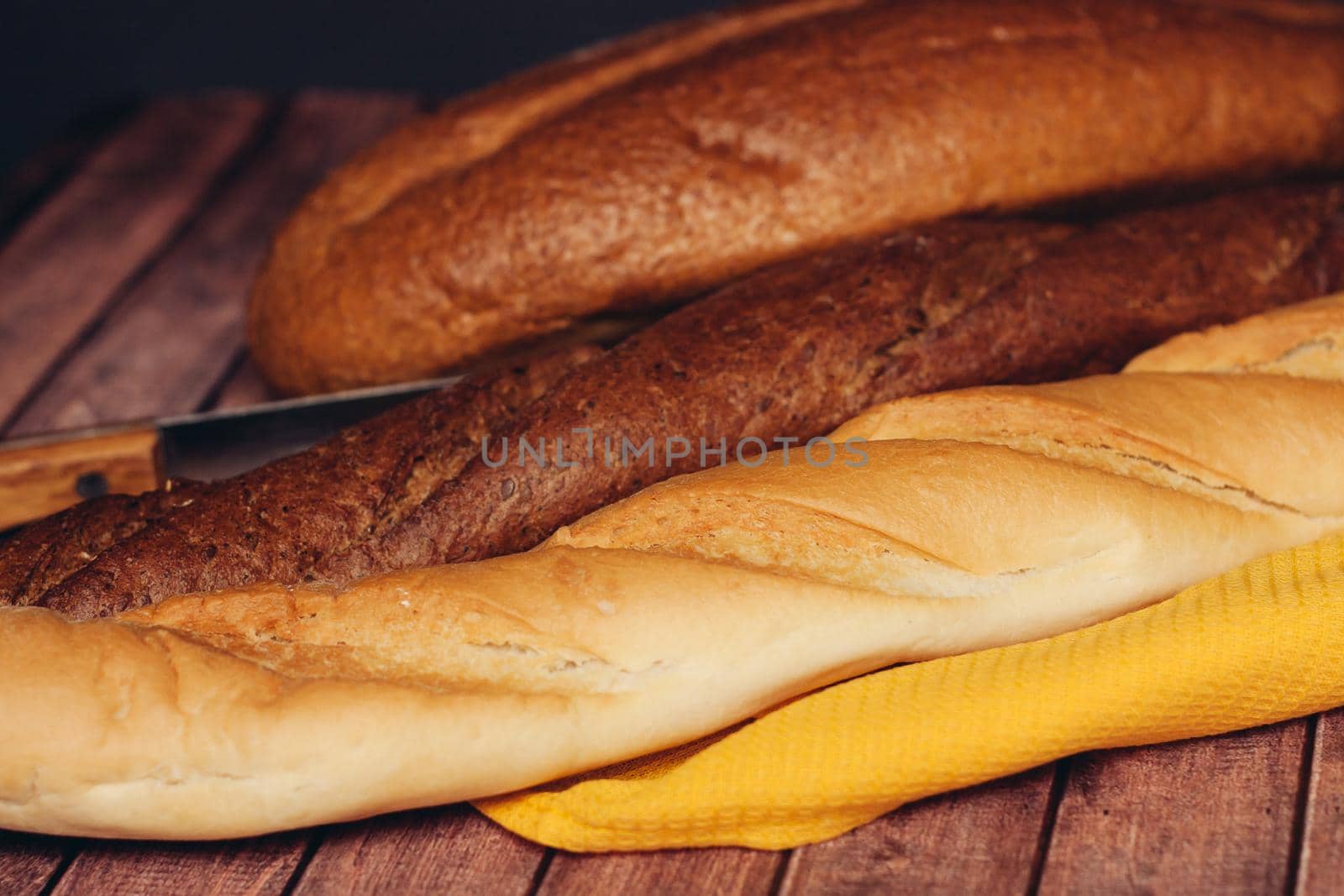 sliced loaf yellow napkin wooden table baked goods. High quality photo