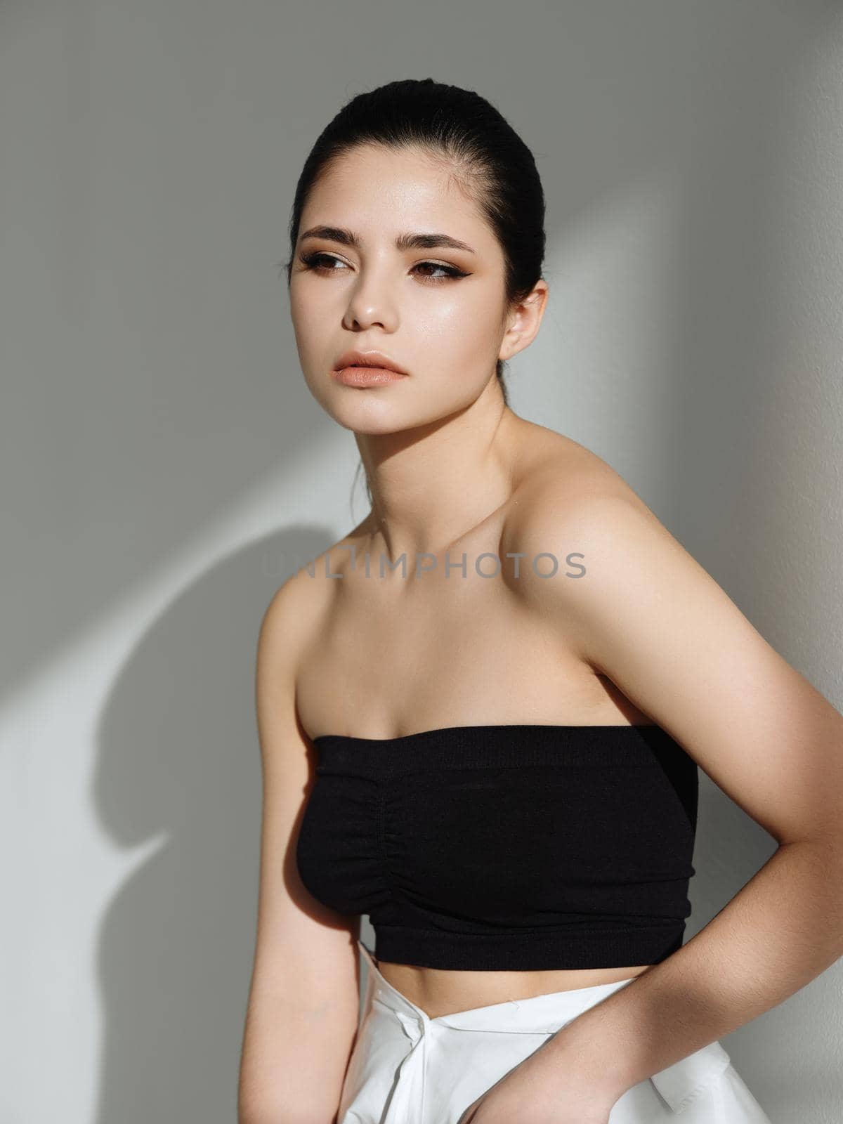 pretty woman naked shoulders enigmatic look fashion studio. High quality photo