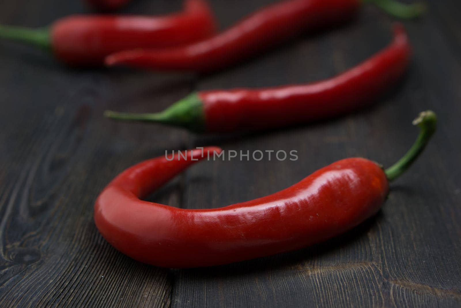 Hot peppers on a wooden background ingredient spicy. High quality photo