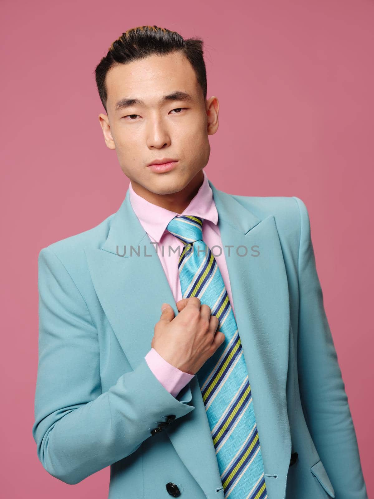 Business man blue suit businessman pink background lifestyle emotions self-confidence. High quality photo