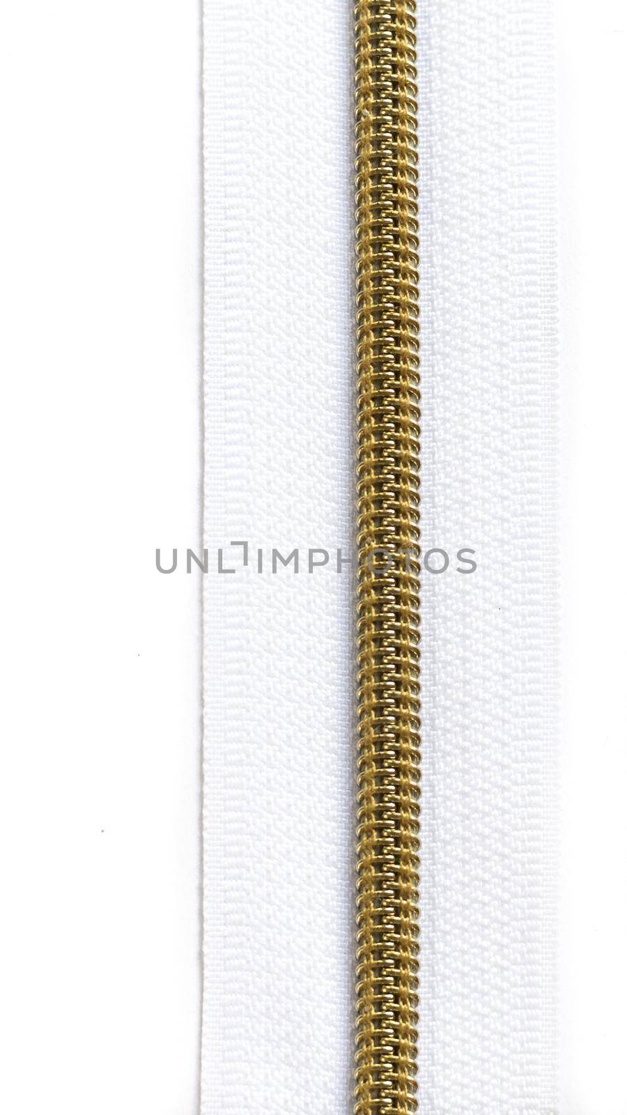 White zipper with gold teeth isolated on white background. Clothing fastener.