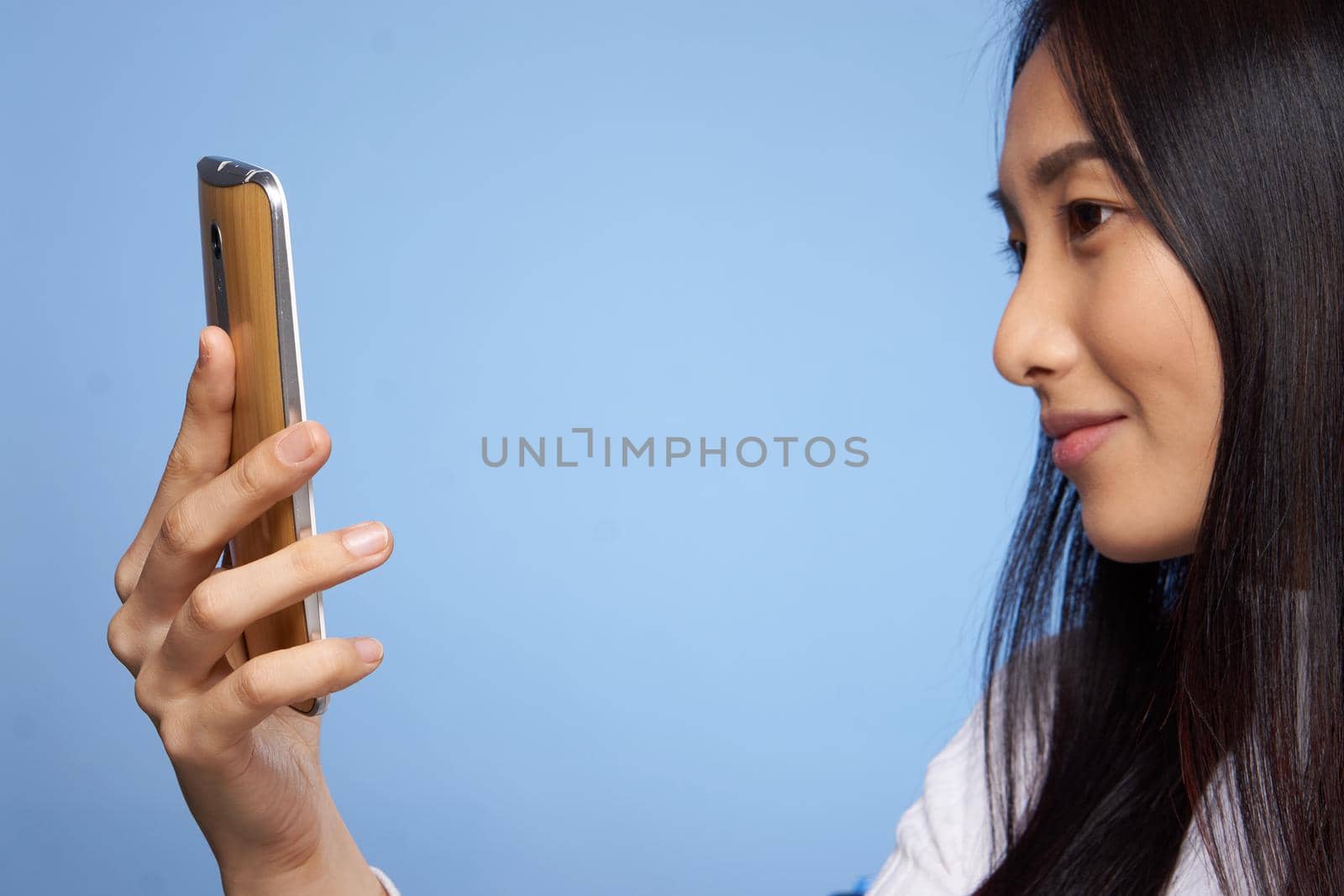 pretty asian woman looking at phone technology communication lifestyle. High quality photo
