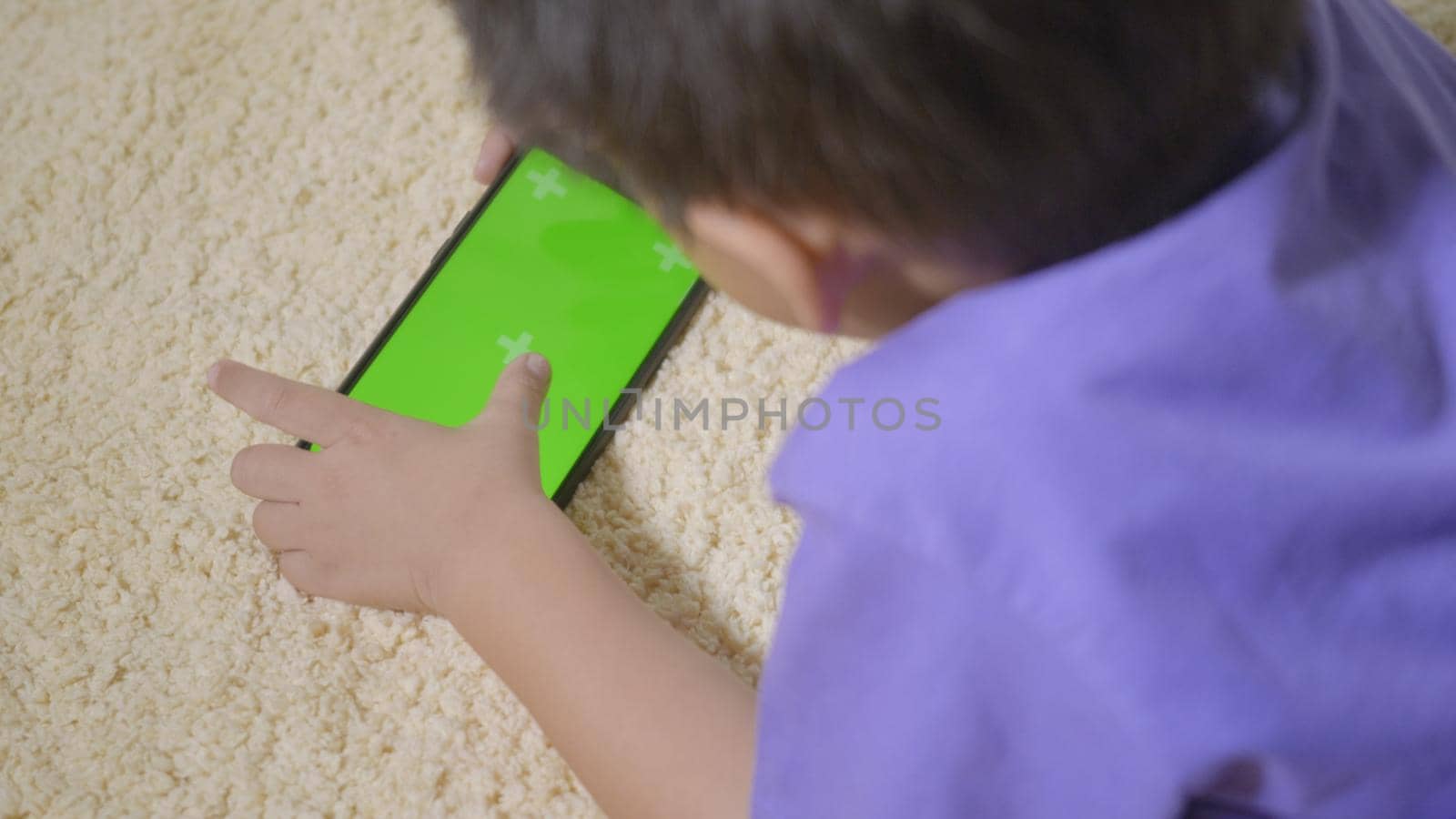 kid boy preschool with gadget playing video games digital on mobile phone by Sorapop