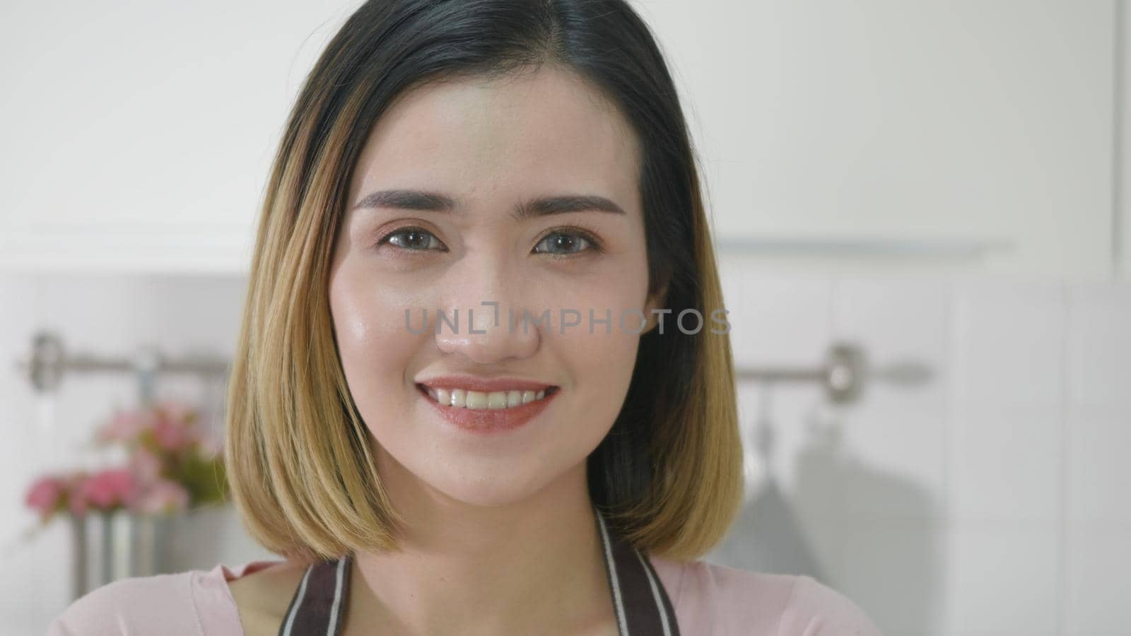 Portrait Asian young happy beautiful woman smiling standing crossing hands on kitchen she looking to camera. female housewife holding arms crossed confident luxury enjoy posing cooking. slow motion