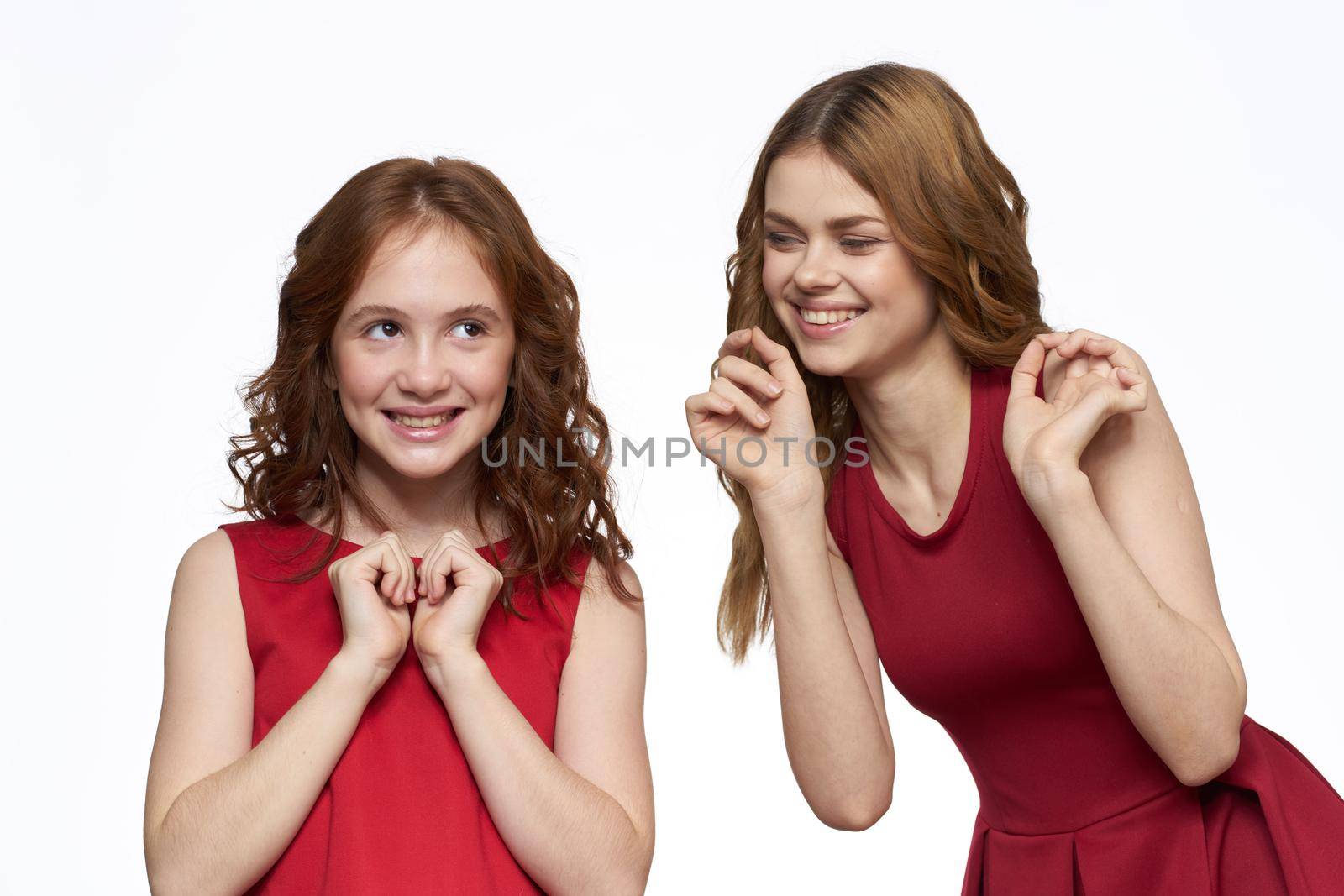 Joyful family fun mom daughter emotions light background. High quality photo