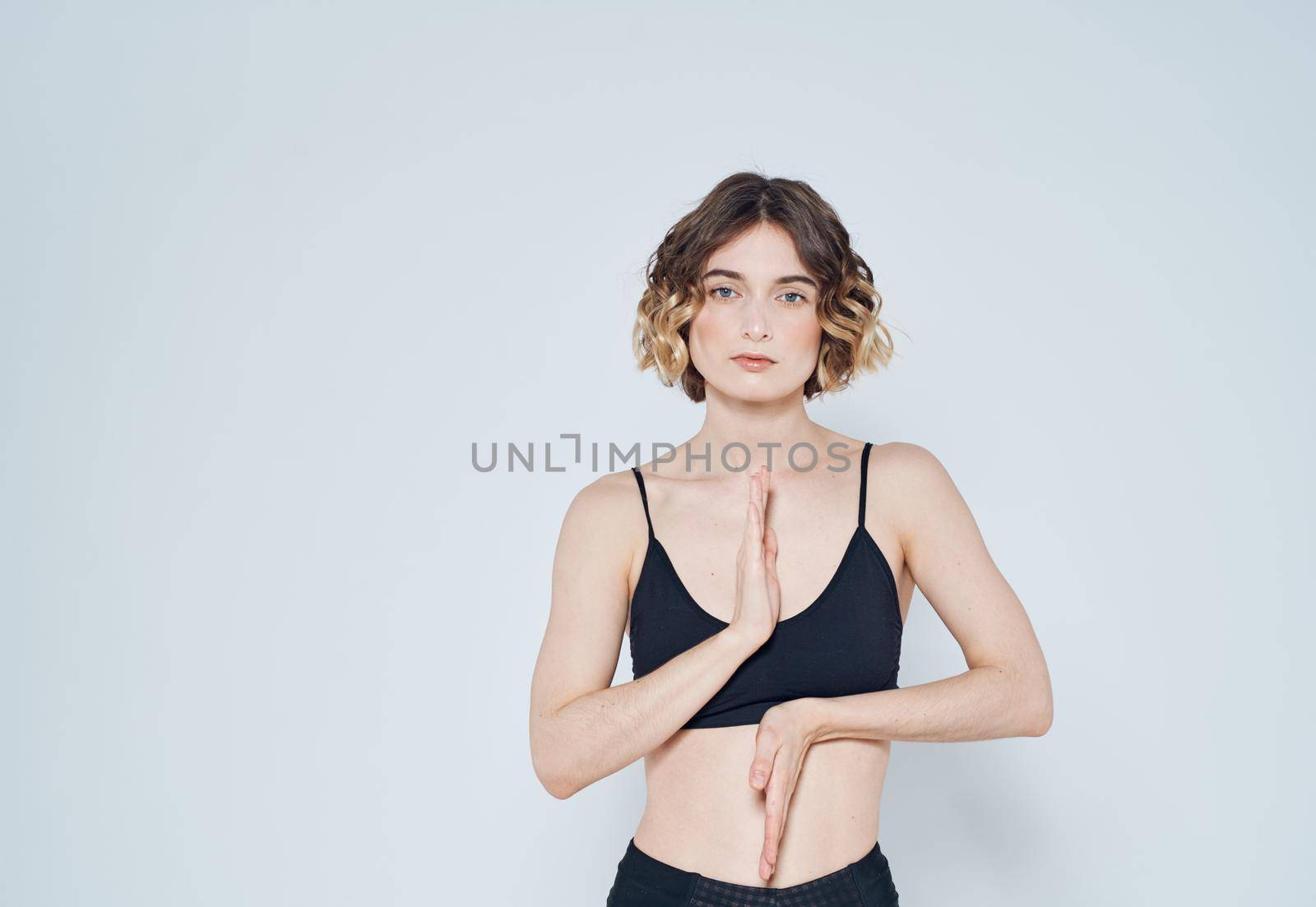 Slender woman in sportswear gestures with her hands yoga meditation. High quality photo