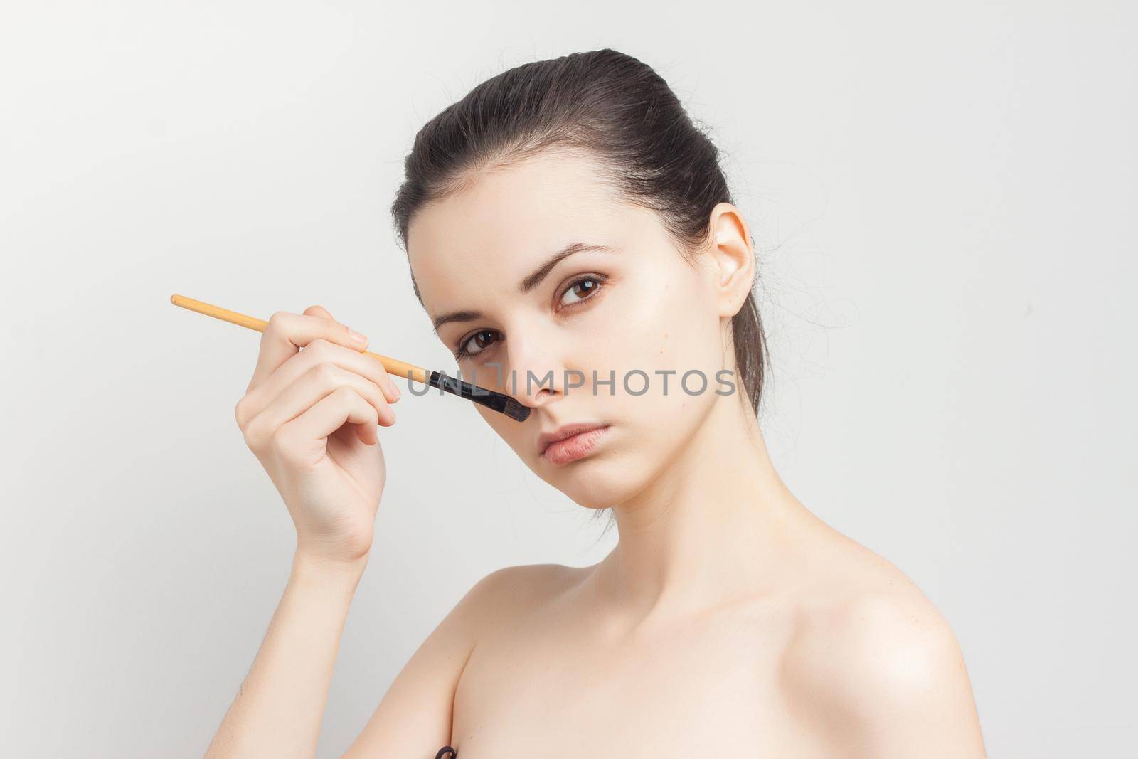woman applying brush cream on face skin care rejuvenation. High quality photo
