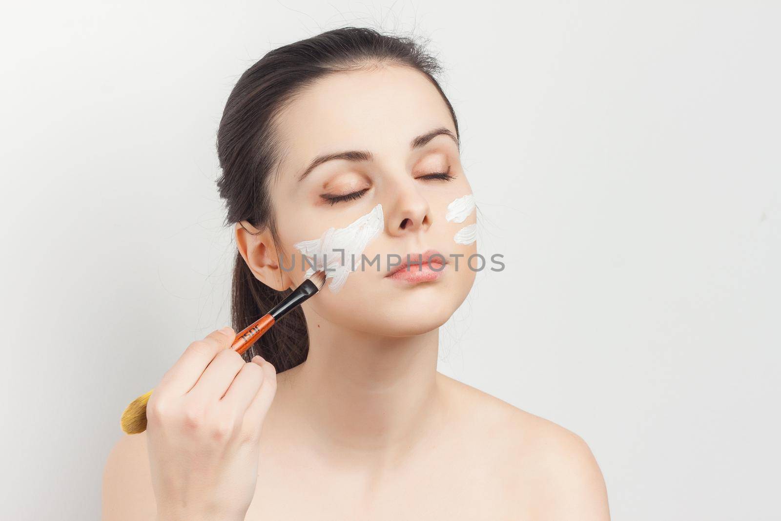 pretty woman naked shoulders face cream skin care cosmetology. High quality photo