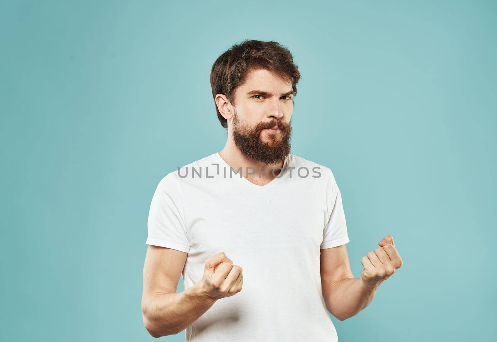 Cute man with beard on blue background emotions Copy Space cropped view. High quality photo