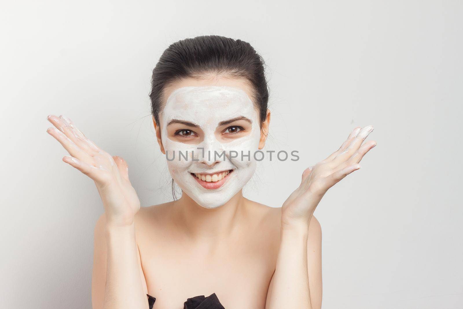 beautiful brunette naked shoulders face cream skin care. High quality photo