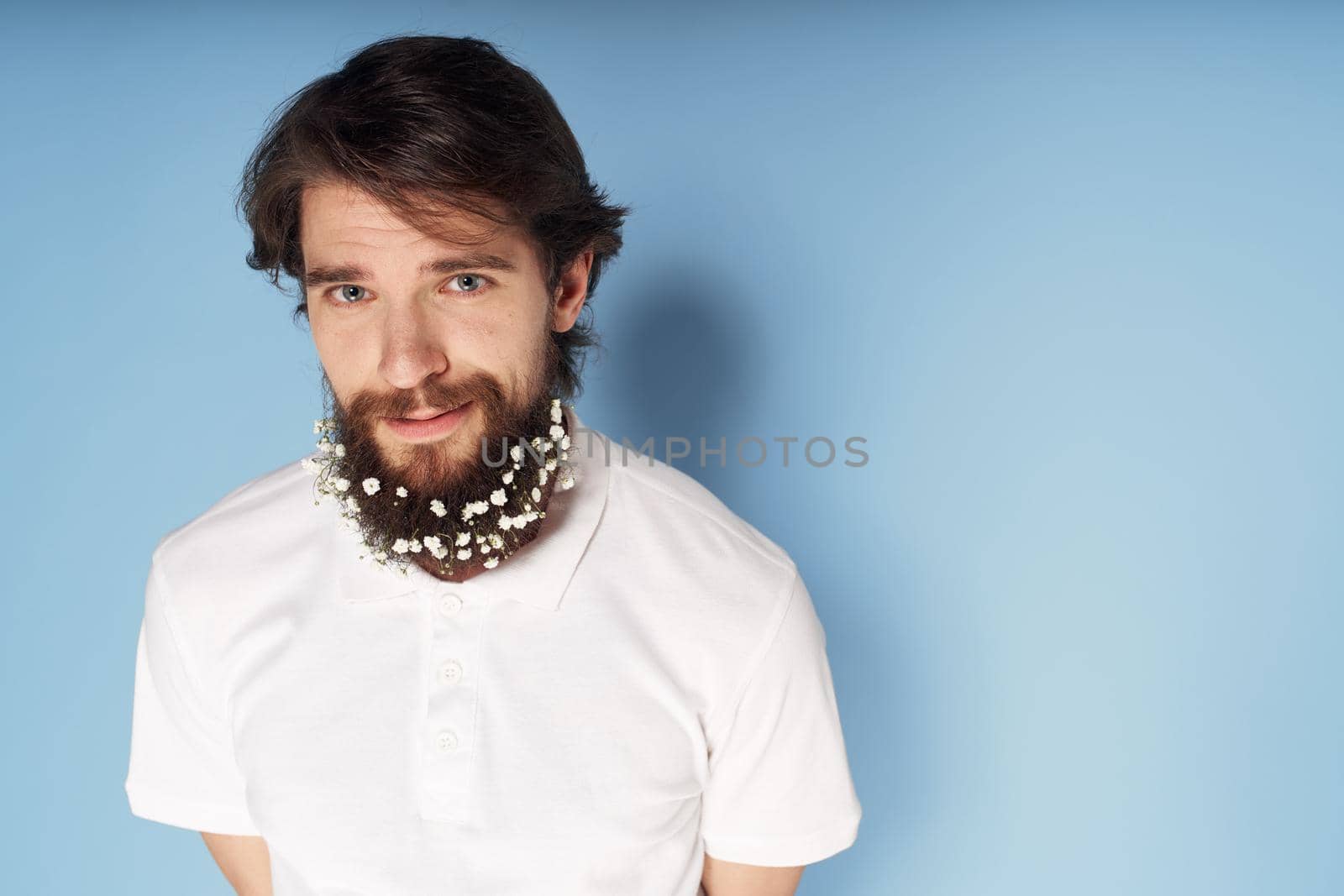 Bearded man white t-shirt barbershop blue background decoration. High quality photo