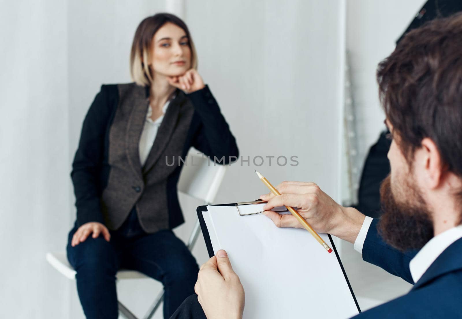A man communicates with a woman and documents are in the hands of a psychologist at a doctor's appointment. High quality photo