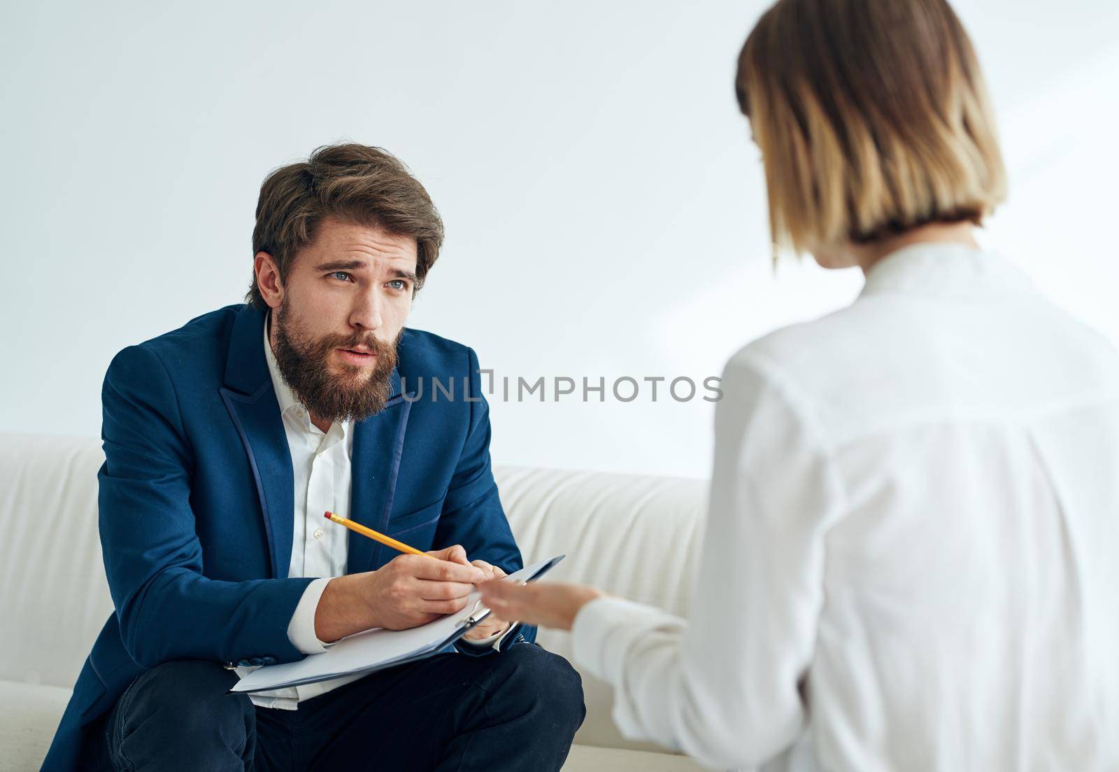 Man and woman sitting on the couch teamwork communication office. High quality photo