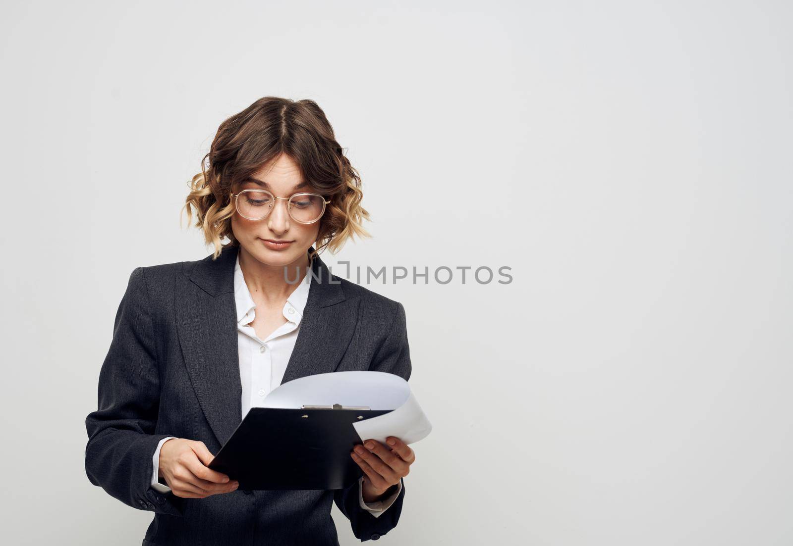 Woman with documents business finance light background classic suit. High quality photo