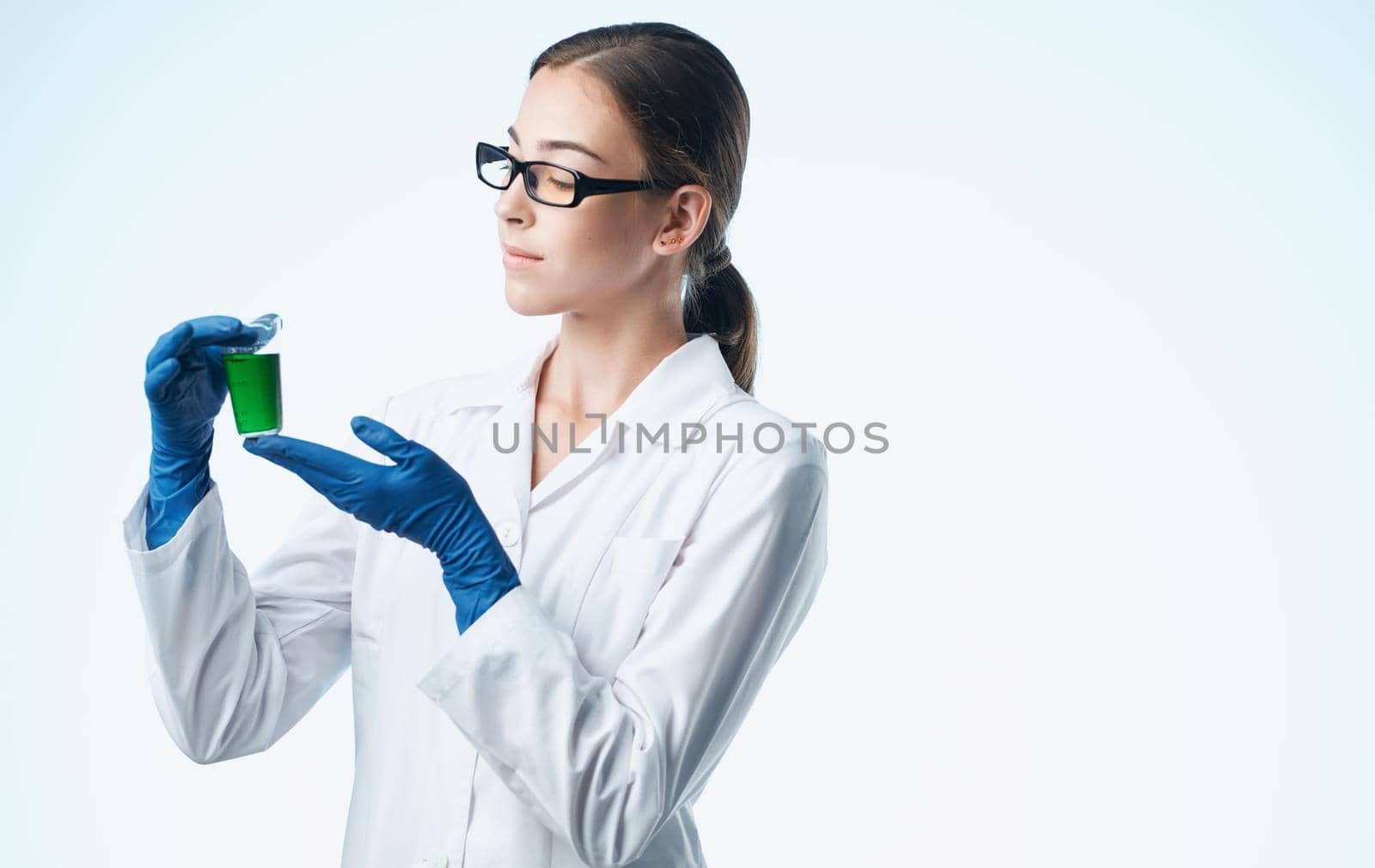 female doctor in a medical gown and blue gloves vaccination tests. High quality photo