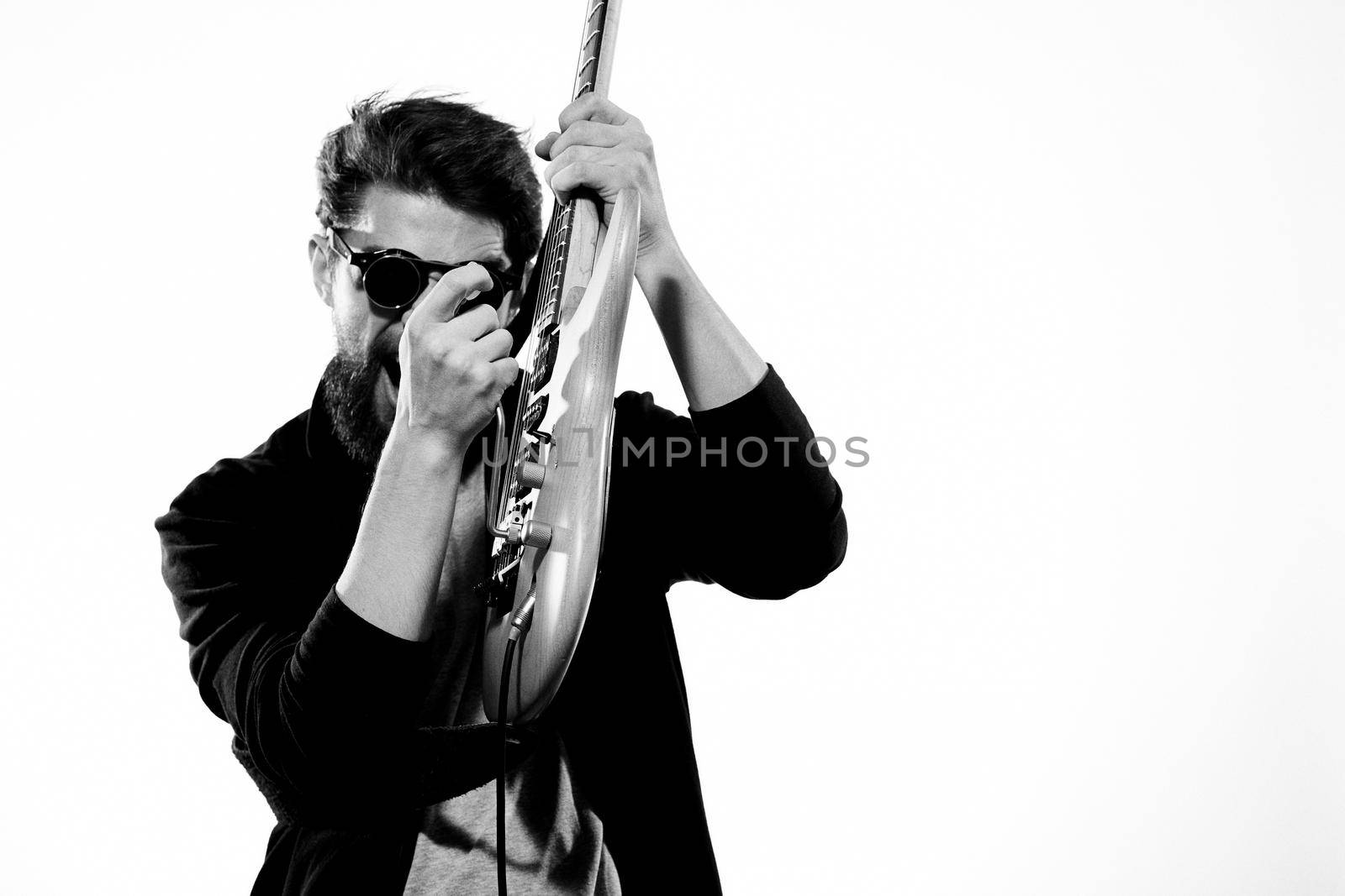 Male music black leather jacket guitar music performed. High quality photo