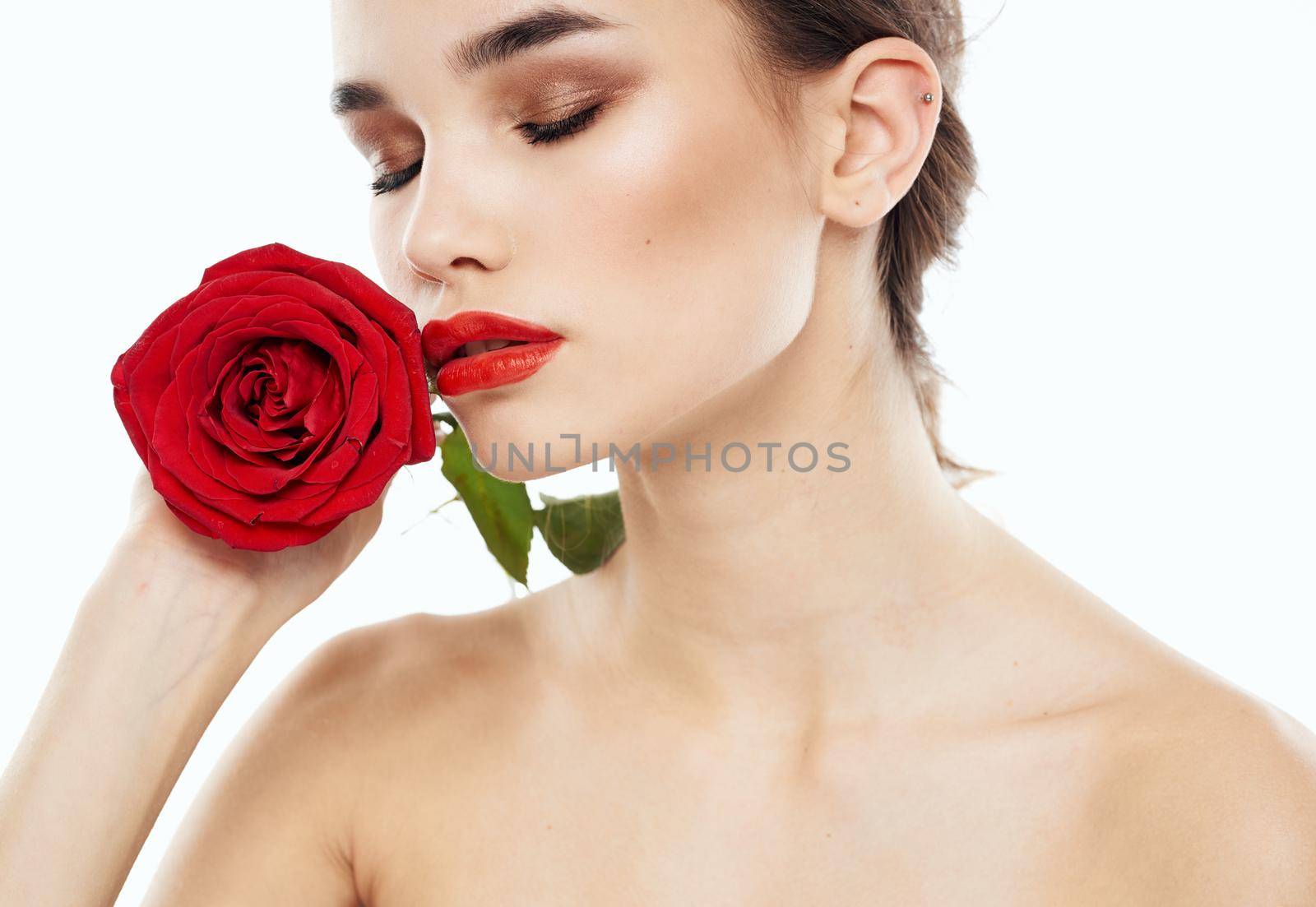 Attractive woman model with bared shoulders and a flower emotion charm. High quality photo