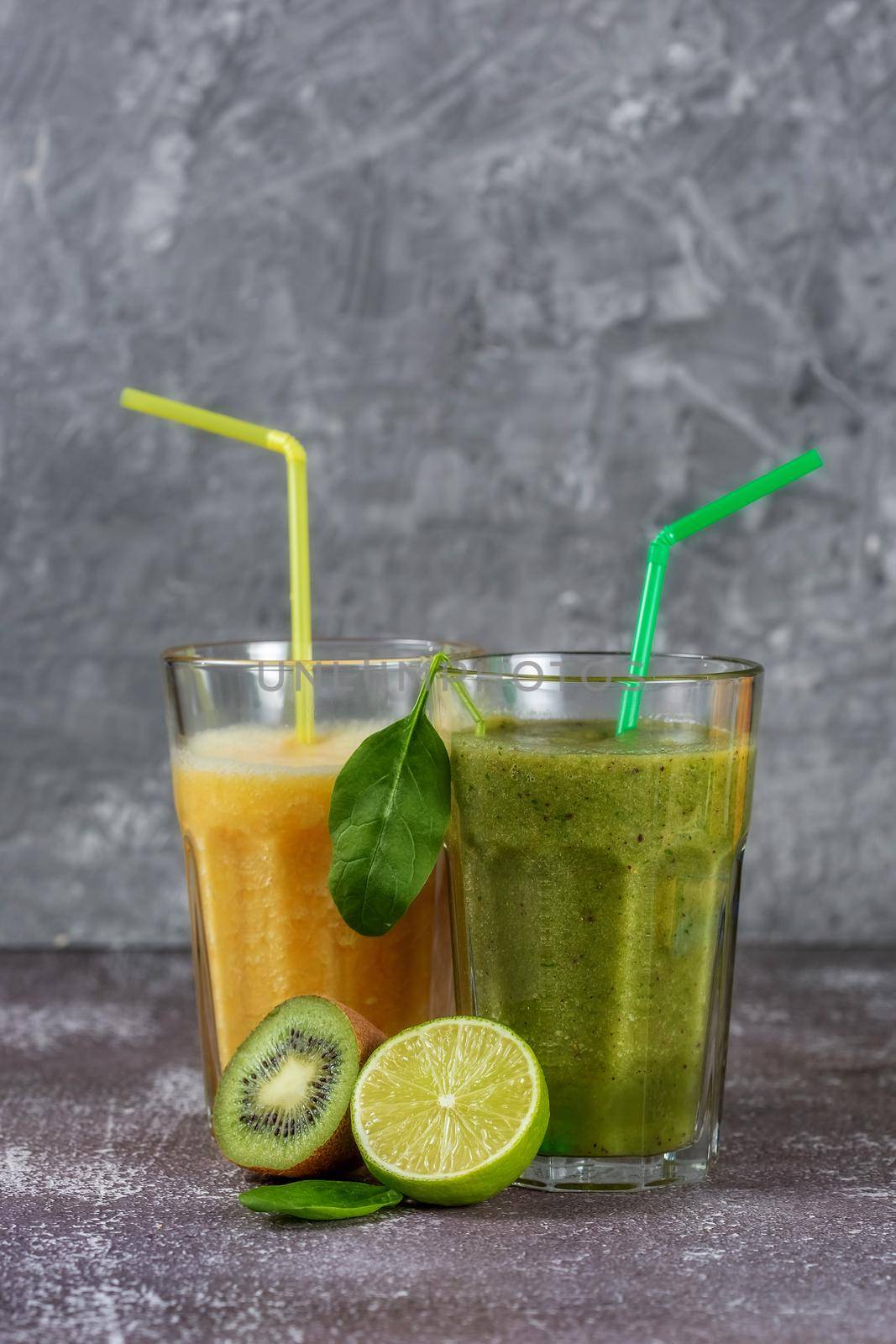 Two tall glasses of orange juice and a banana-orange kiwi and spinach smoothie by galinasharapova
