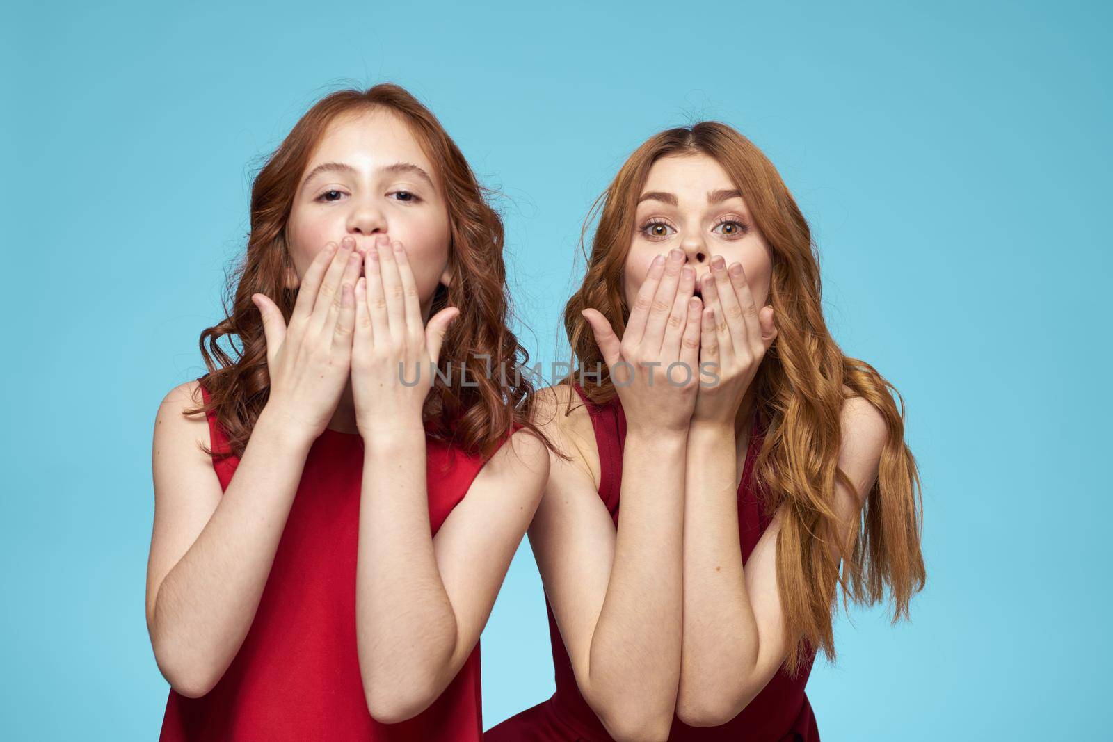 Mom and daughter fun friendship communication blue background. High quality photo