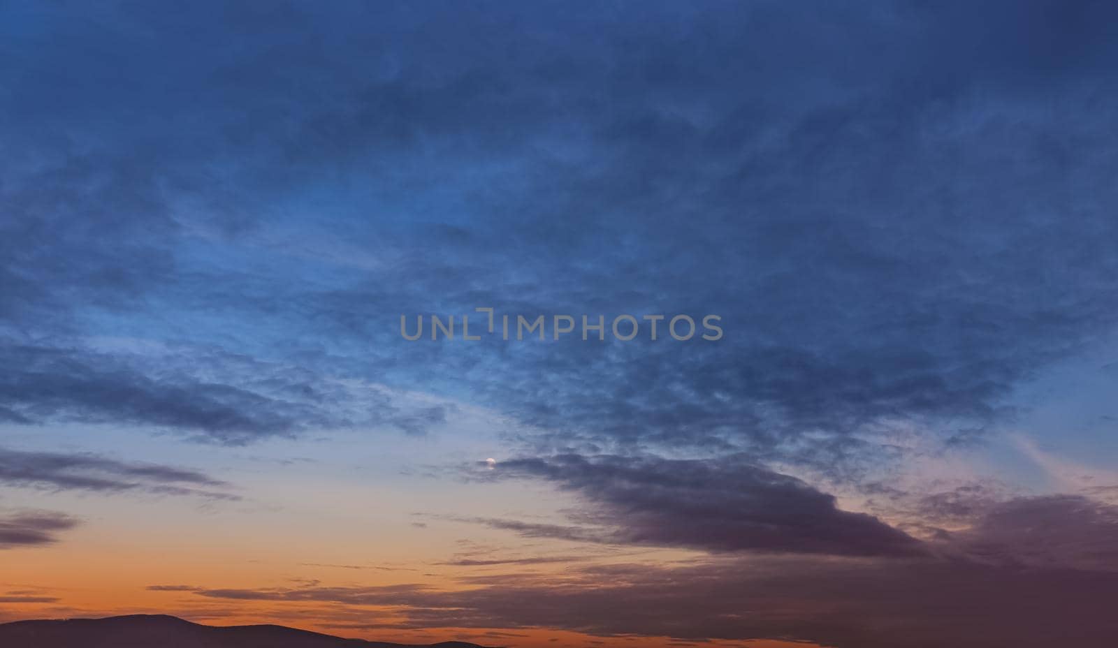 Evening sky with clouds and moon