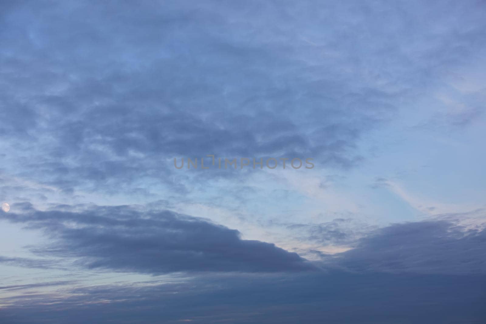 Evening sky with clouds and moon