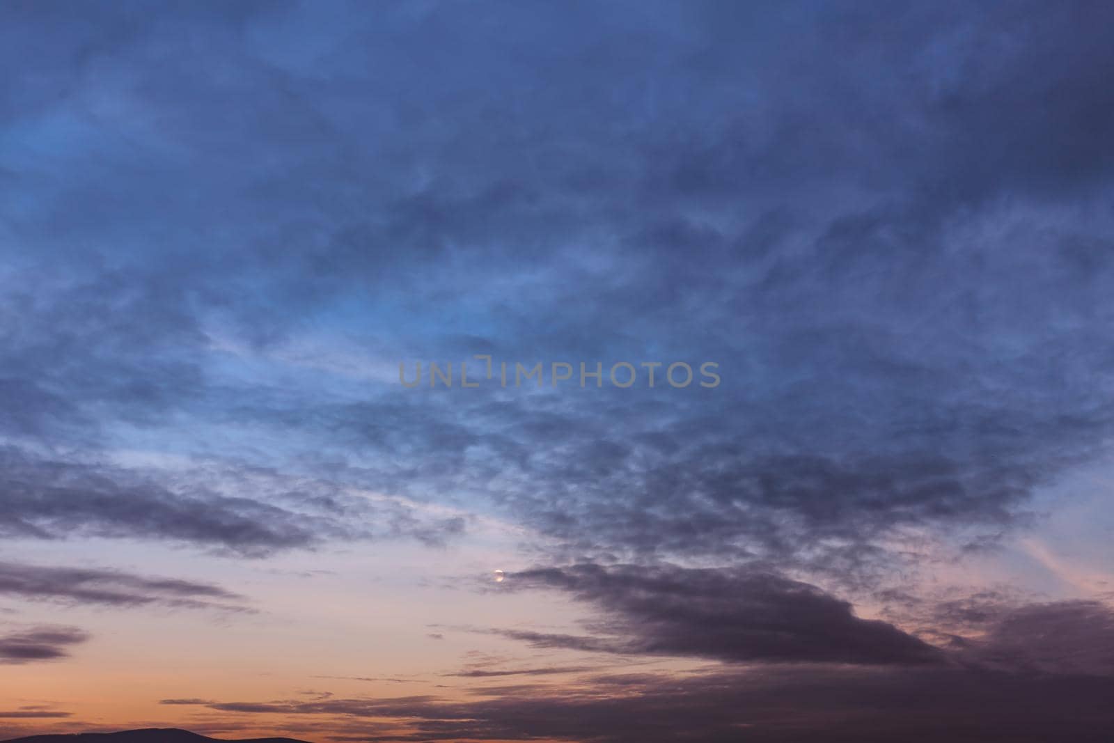 Evening sky with clouds and moon