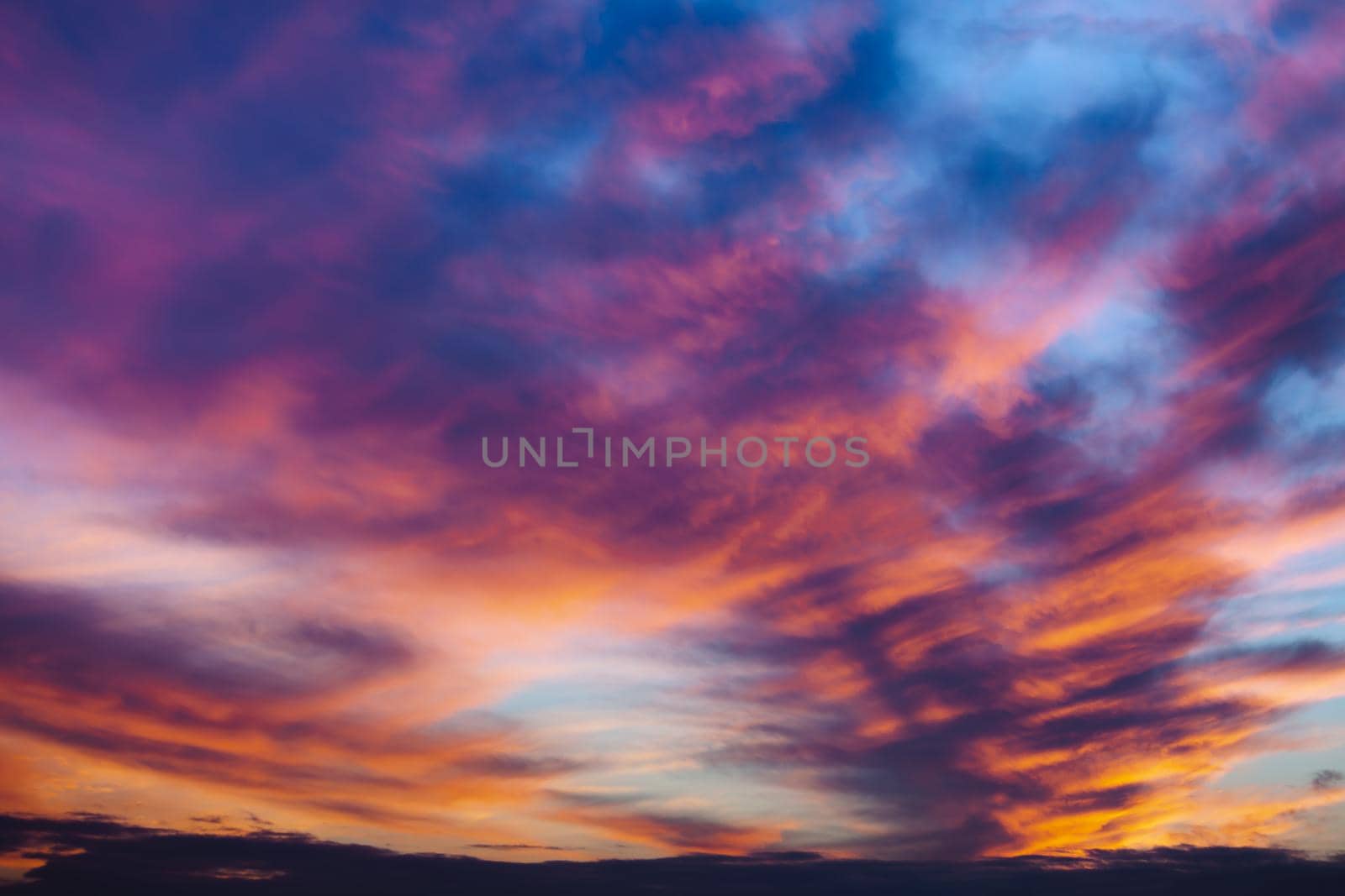 Abstract nature background. Colorful dramatic sky with cloud at sunset. Dramatic and moody pink, purple and blue cloudy sunset sky