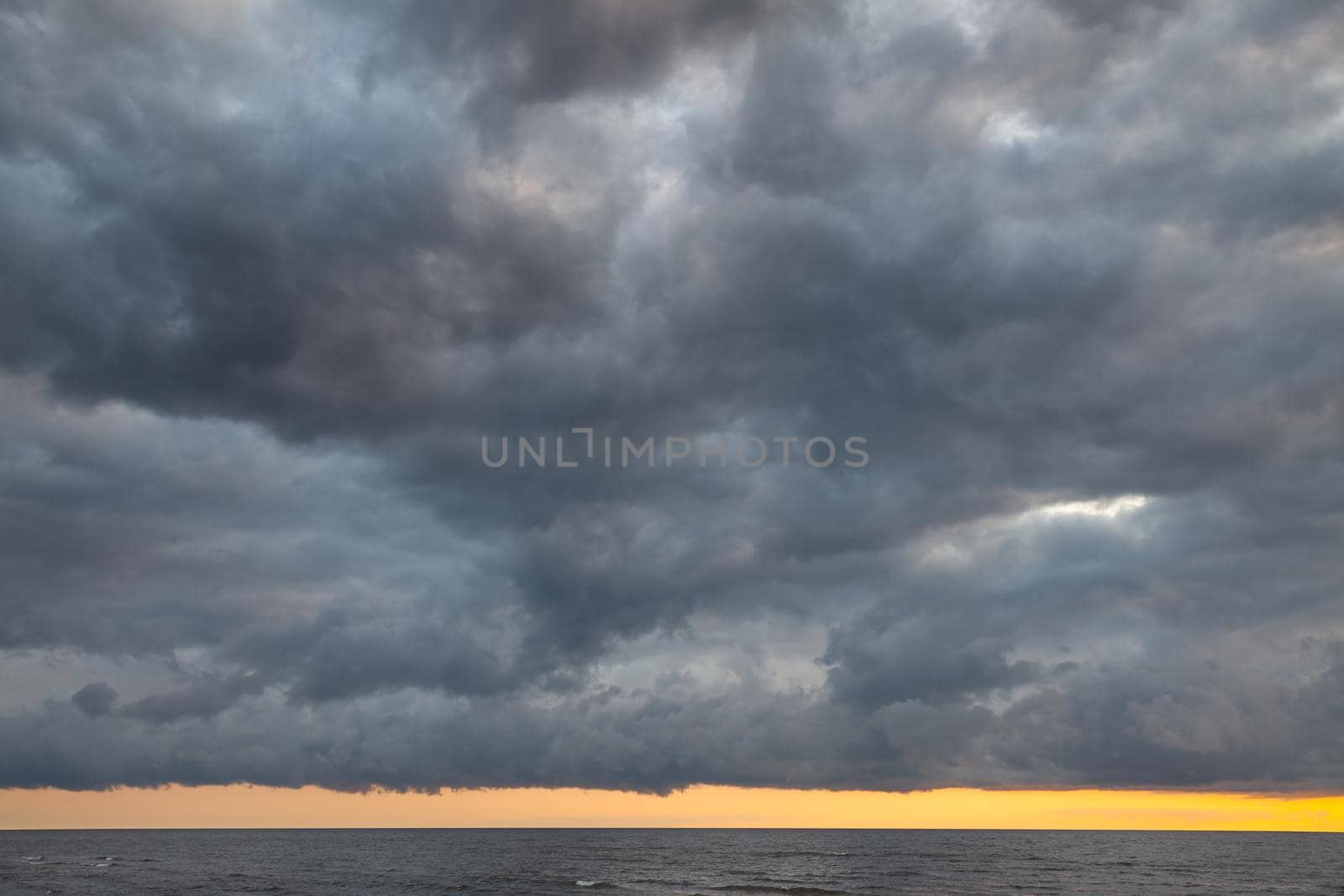 Dramatic sky with stormy clouds over the sea. Nature background