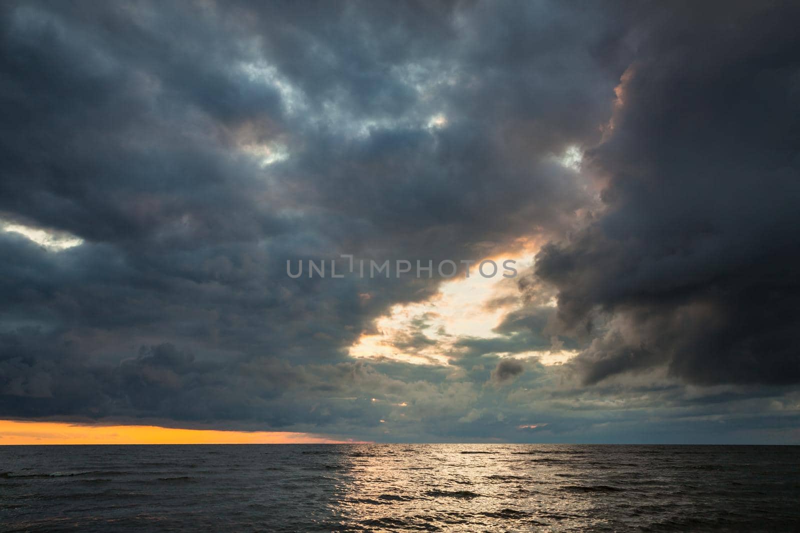 Dramatic sky with stormy clouds over the sea. Nature background