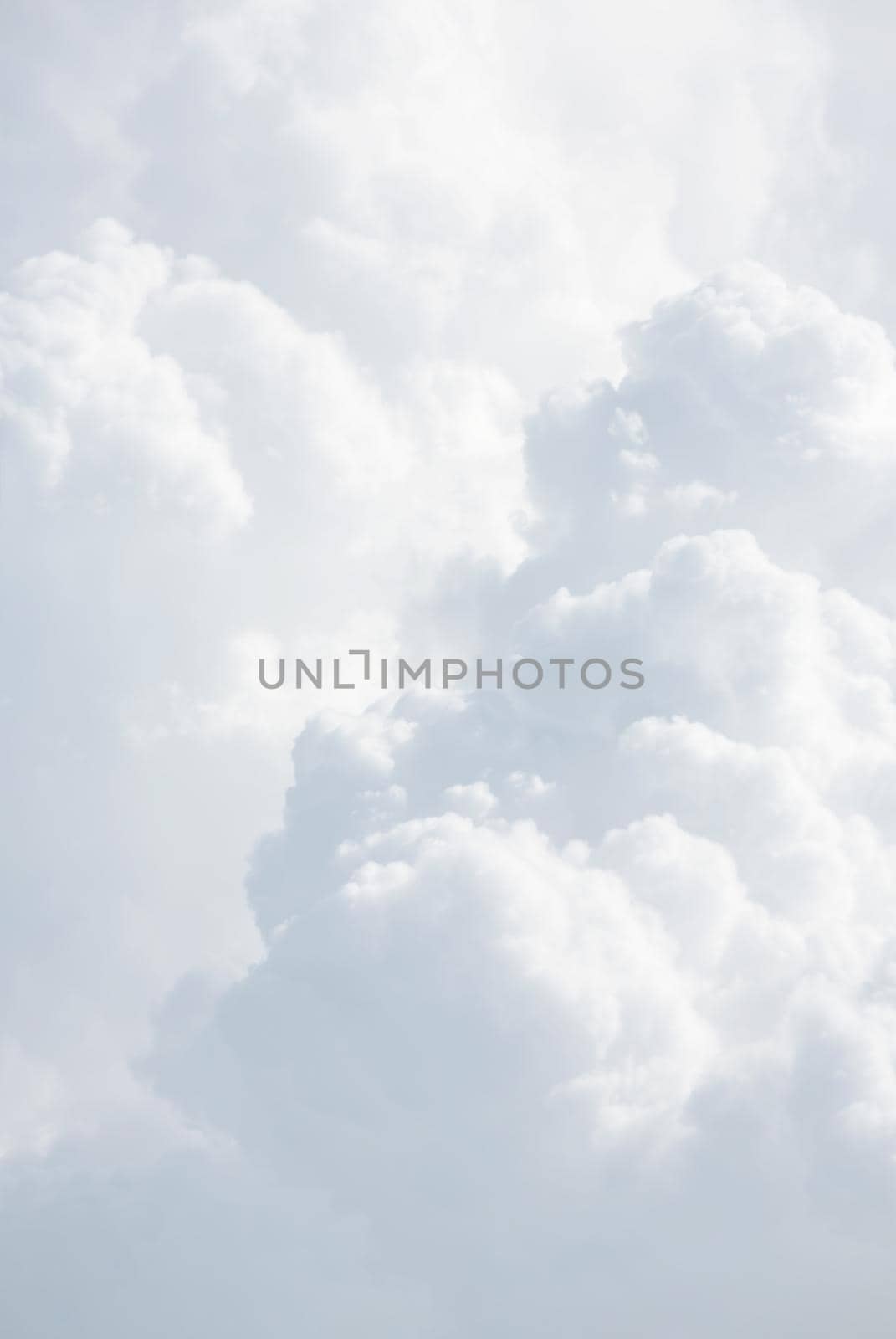 Sky with clouds, a view from an aeroplane above the clouds. Abstract nature background with clouds in light tonality. White cumulus clouds