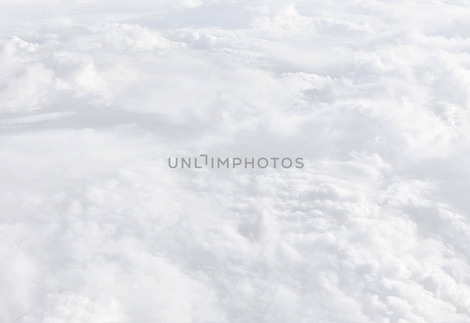 Sky with clouds, a view from an aeroplane above the clouds. Abstract nature background with clouds in light tonality. White cumulus clouds