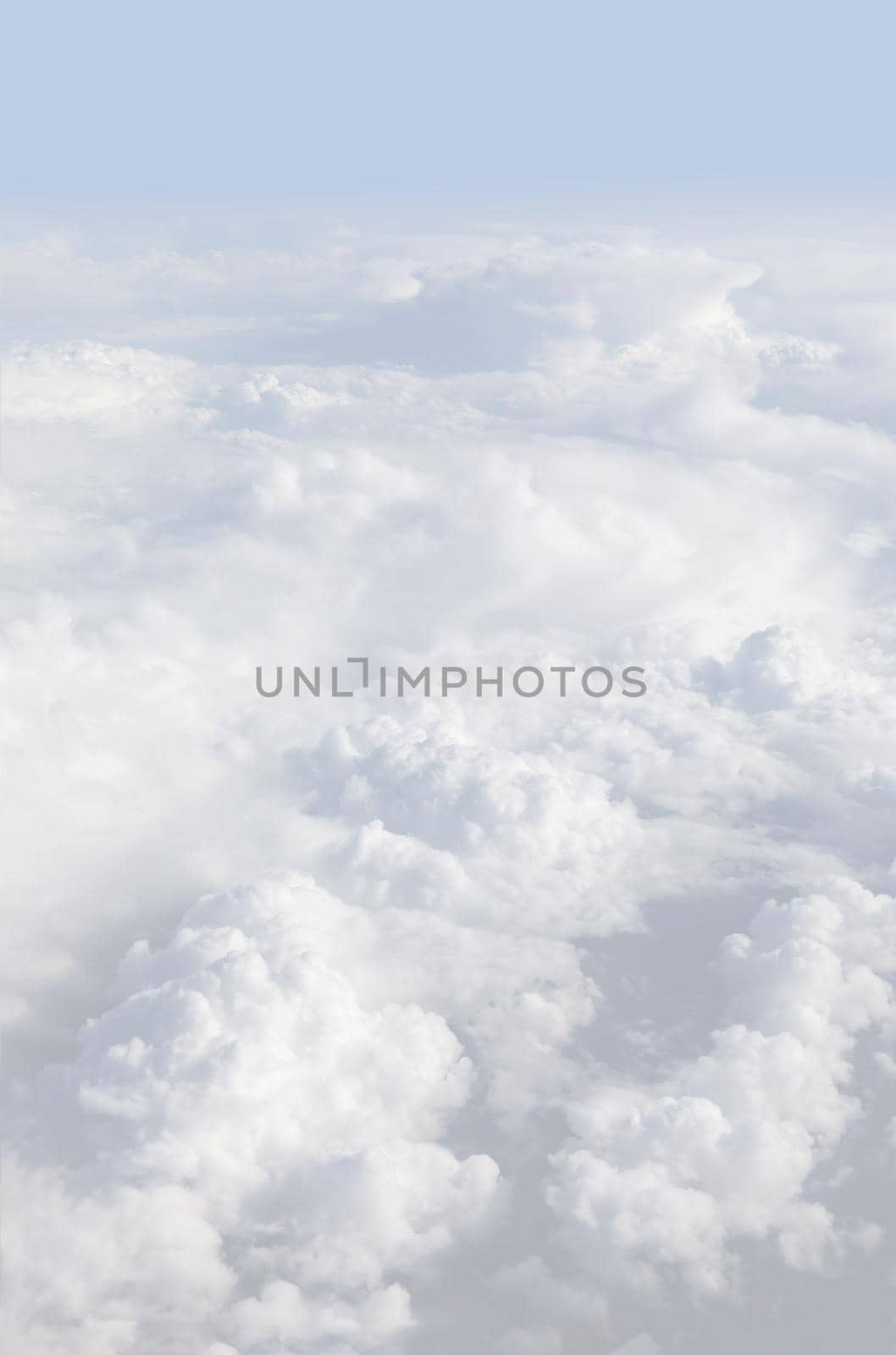Sky with clouds, a view from an aeroplane above the clouds. Abstract nature background with clouds in light tonality. White cumulus clouds