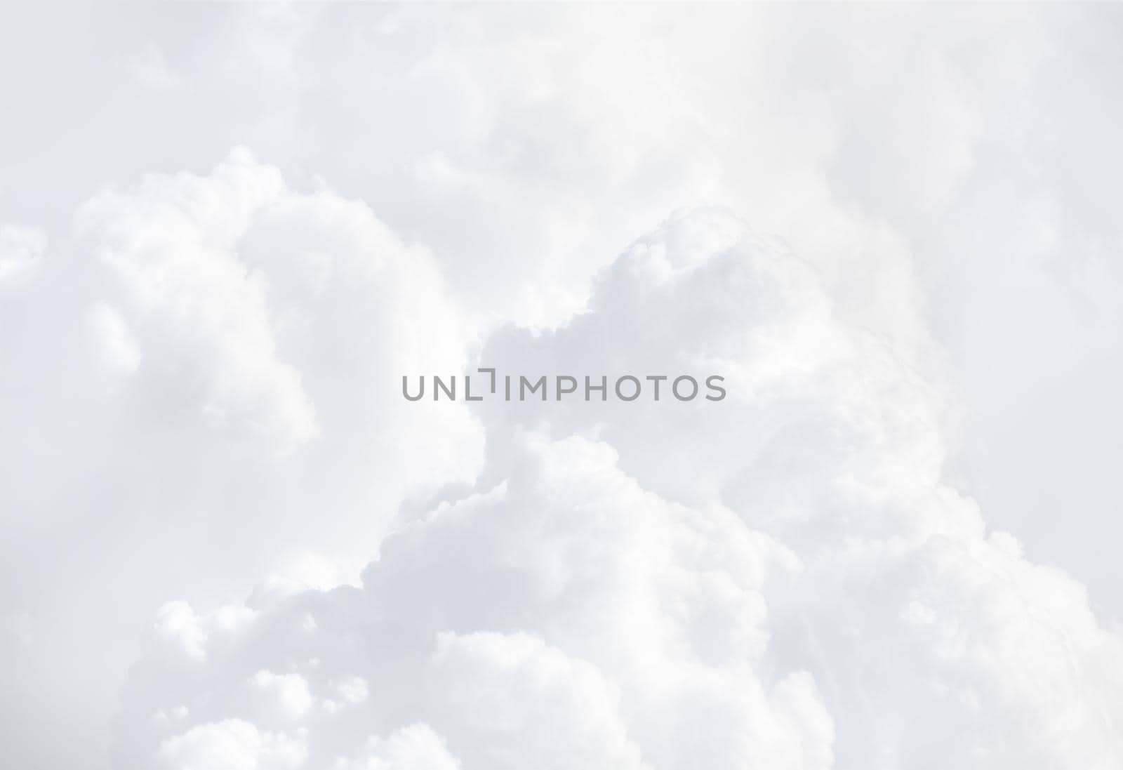 Sky with clouds, a view from an aeroplane above the clouds. Abstract nature background with clouds in light tonality. White cumulus clouds