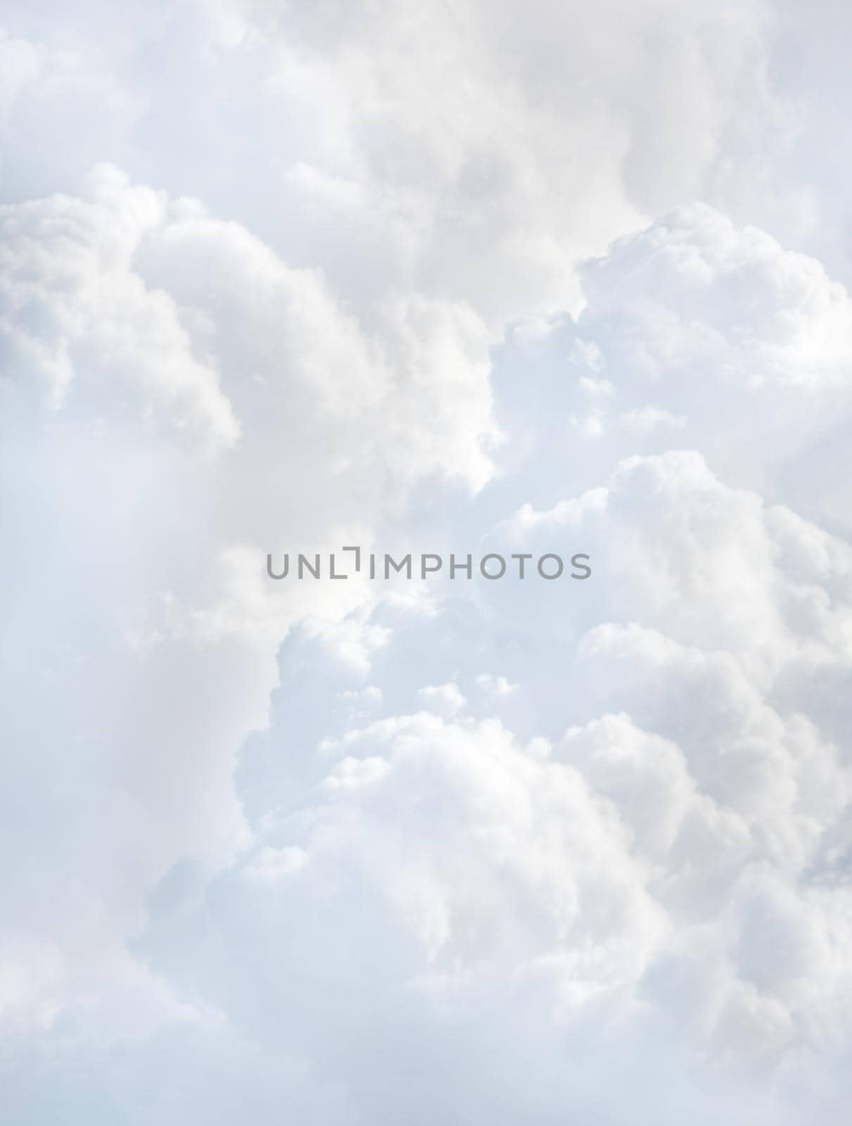Sky with clouds, a view from an aeroplane above the clouds. Abstract nature background with clouds in light tonality. White cumulus clouds